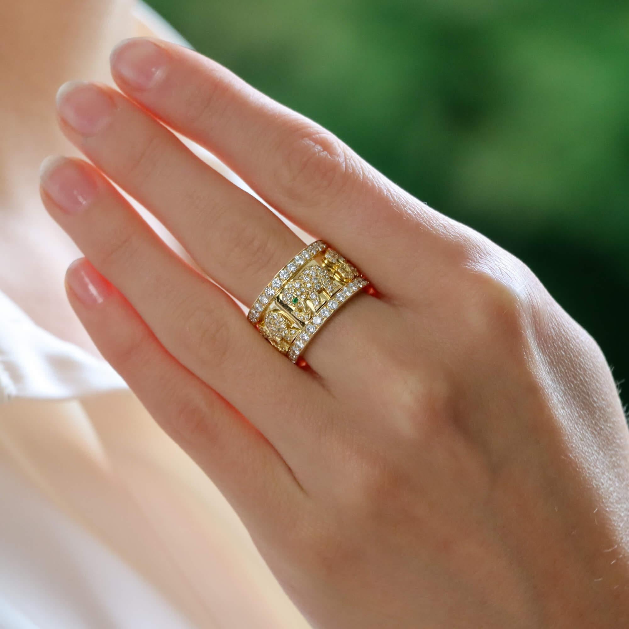 A truly beautiful vintage Cartier walking elephant emerald and diamond ring set in 18k yellow gold.

The ring is set with five stylized elephants, each beautifully pave set with round brilliant cut diamonds and accented with a round cut emerald eye.