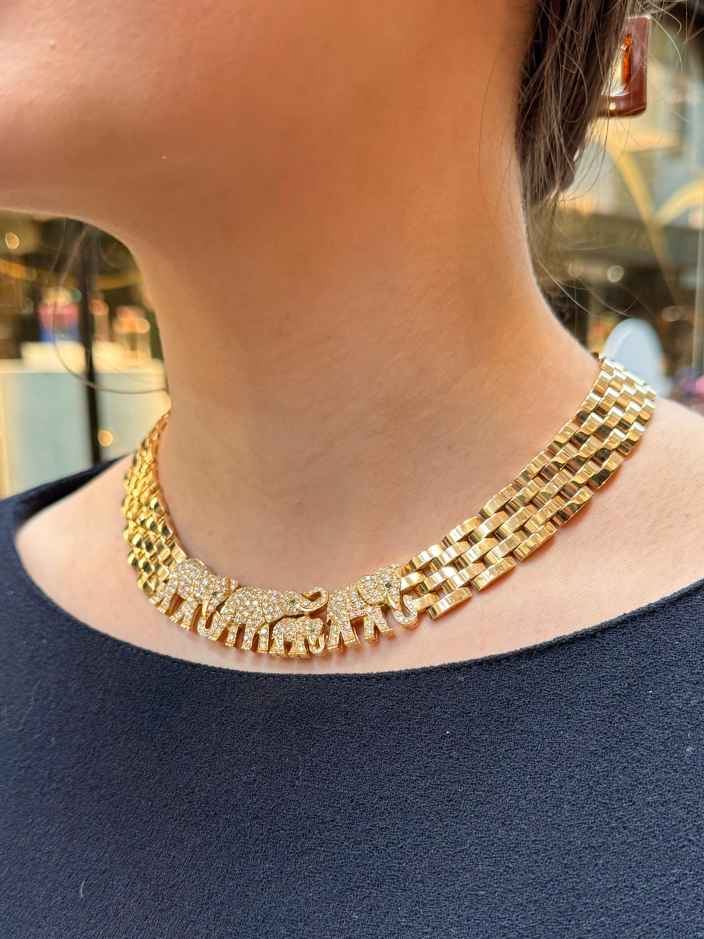 A simply stunning vintage Cartier Paris diamond Elephant Maillon necklace set in solid 18k yellow gold; circa early 1998.

The necklace is composed of a central panel which depicts a family of four walking elephants. The elephants are pave set with
