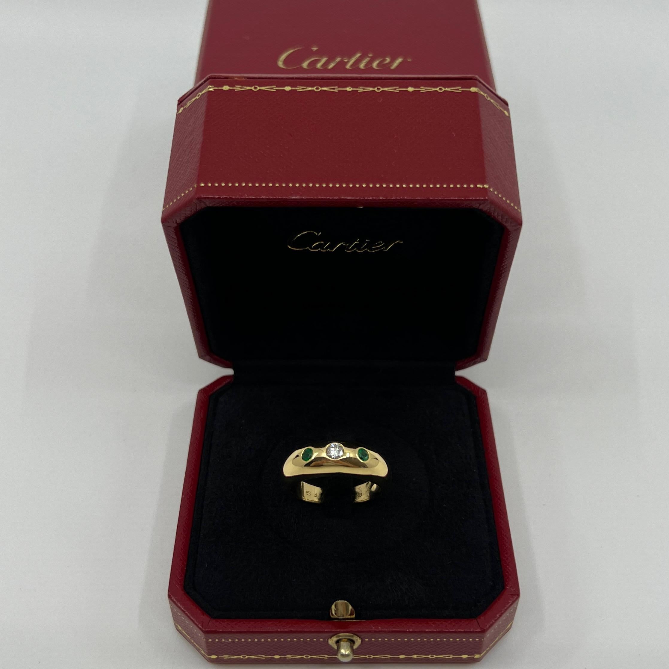 Large Size Vintage Cartier Diamond And Emerald 18k Yellow Gold Three Stone Dome Signet Ring.

Stunning yellow gold Cartier ring set with a beautiful 3.5mm centre diamond with F/G Colour and VVS clarity. This is accented by 2 fine green emeralds