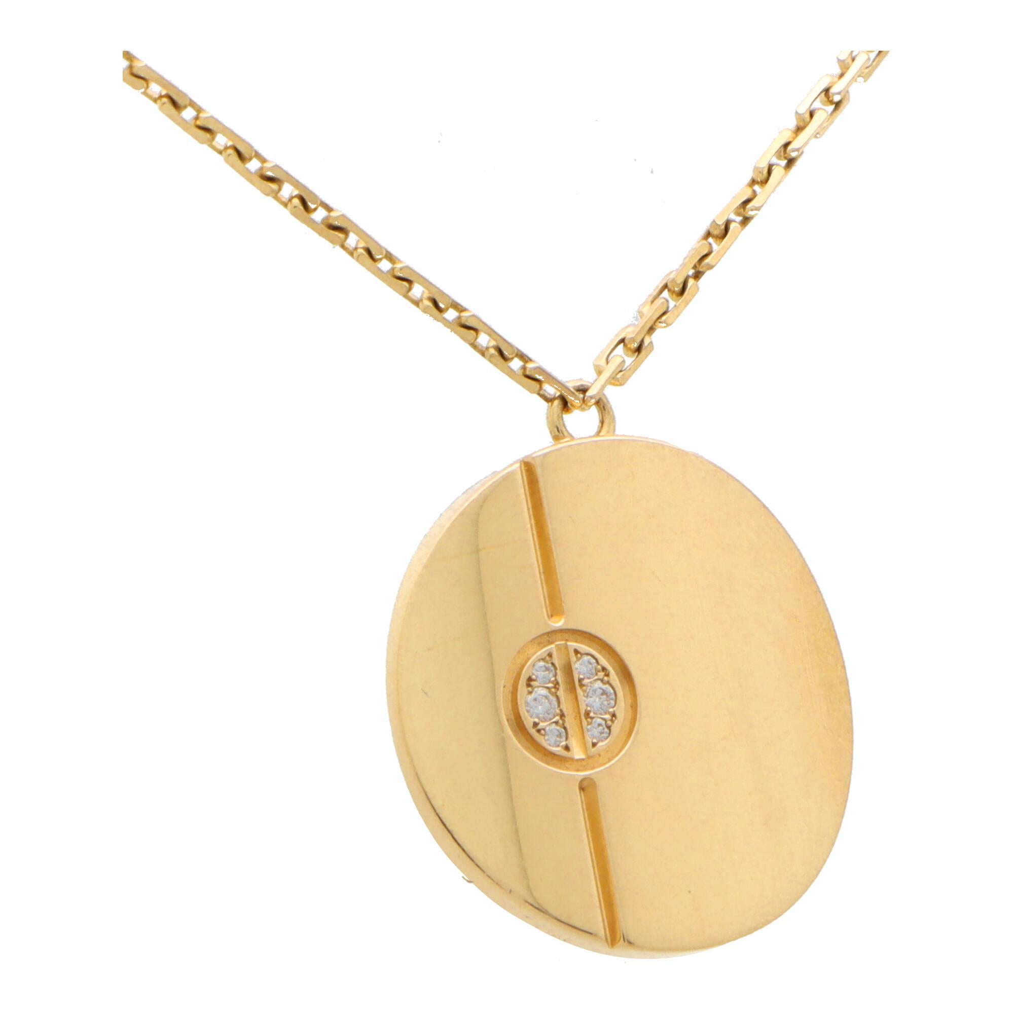 A beautiful vintage Cartier diamond Love set in 18k yellow gold.

The necklace is composed of a solid yellow gold disc set off centre with the iconic Cartier Love nail motif. The pendant hangs from a signed Cartier 18-inch chain which is included