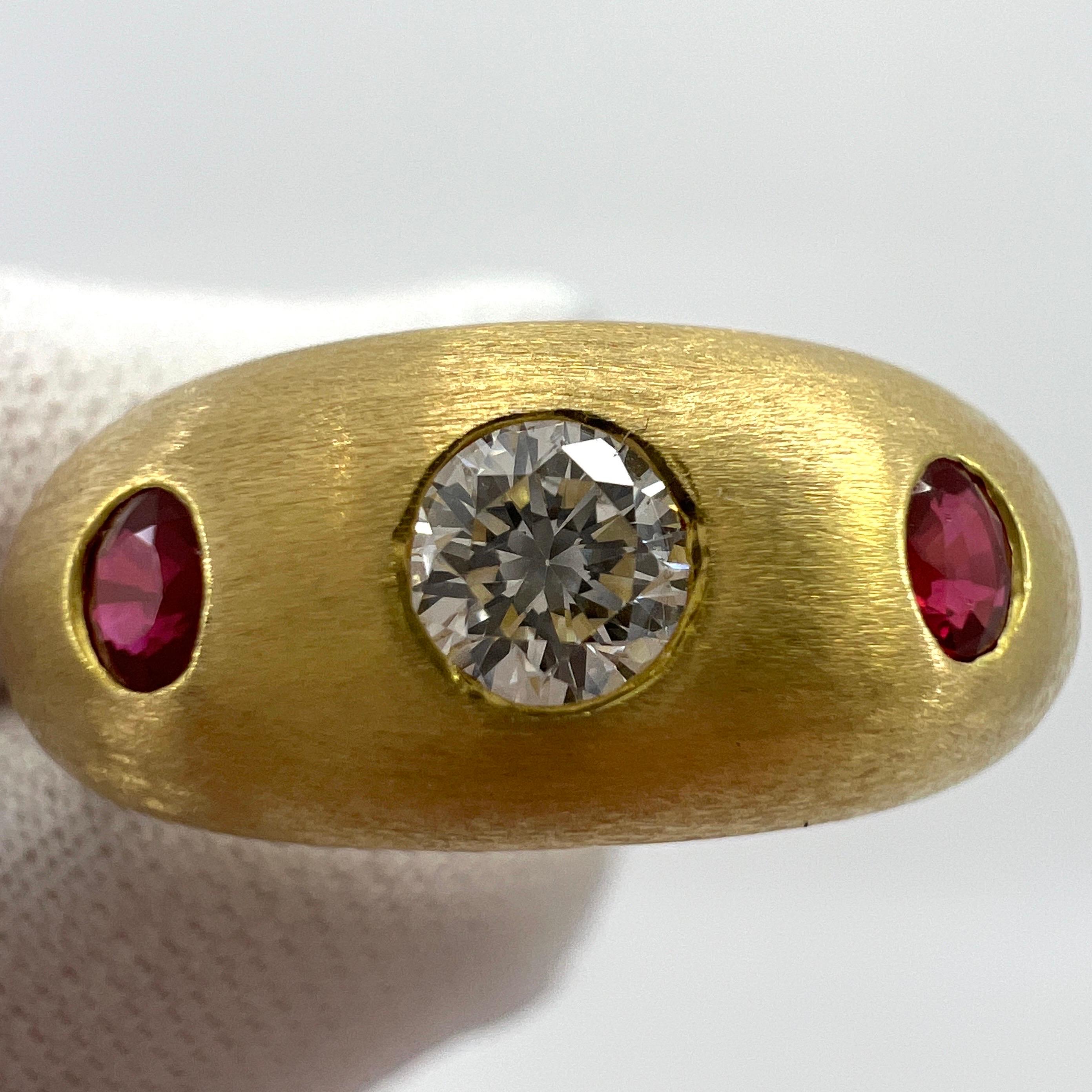 Vintage Cartier Diamond & Ruby 18k Brushed Yellow Gold Three Stone Domed Ring.

Stunning yellow gold Cartier ring set with a beautiful 3.5mm centre diamond with F/G Colour and VVS clarity. This is accented by 2 fine deep red rubies approx 2.5mm