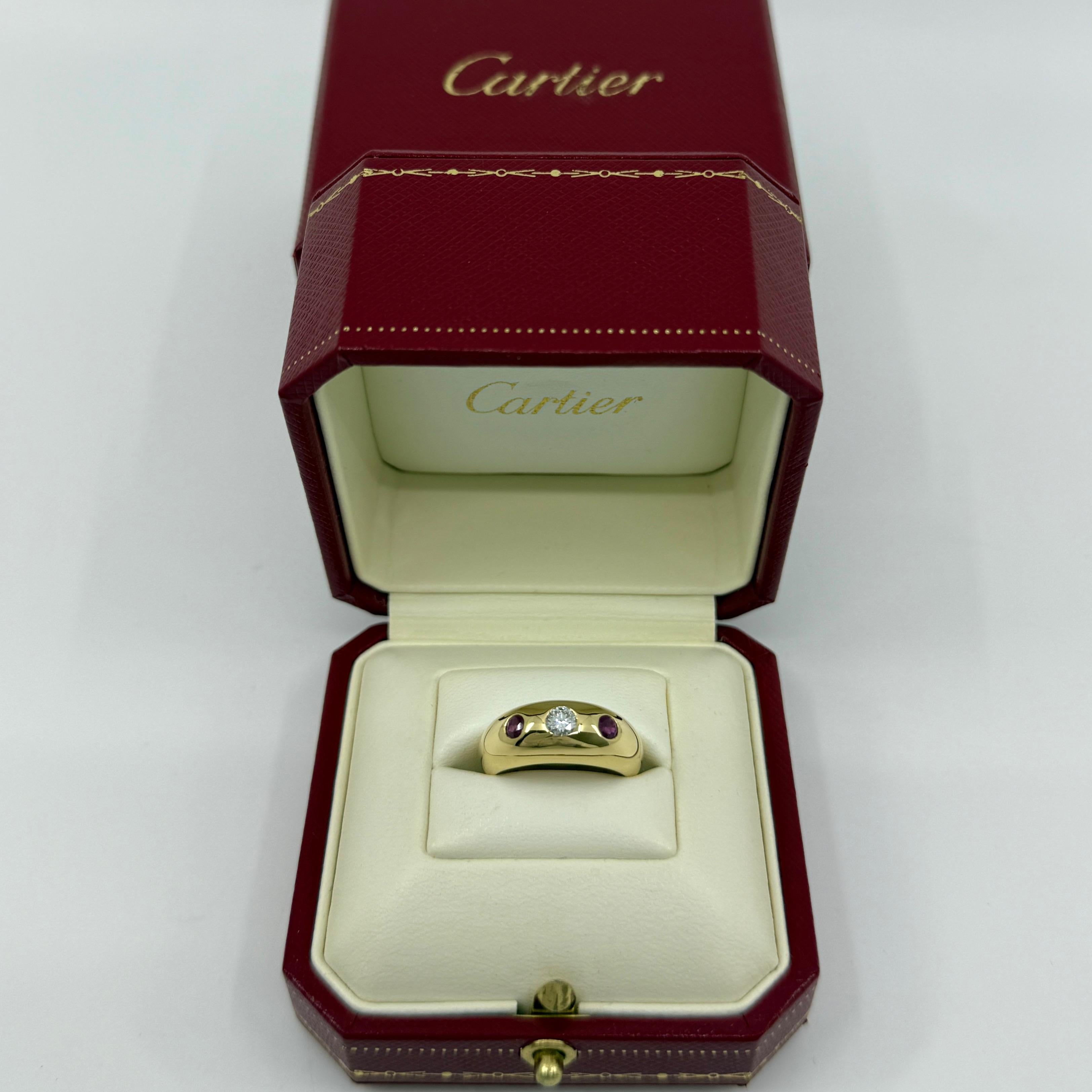 Rare Vintage Cartier Diamond & Ruby 18k Yellow Gold Three Stone Daphne Ring.

Stunning yellow gold Cartier ring set with a beautiful 4mm centre diamond with F/G Colour and VVS clarity. This is accented by 2 fine deep red rubies approx. 3mm