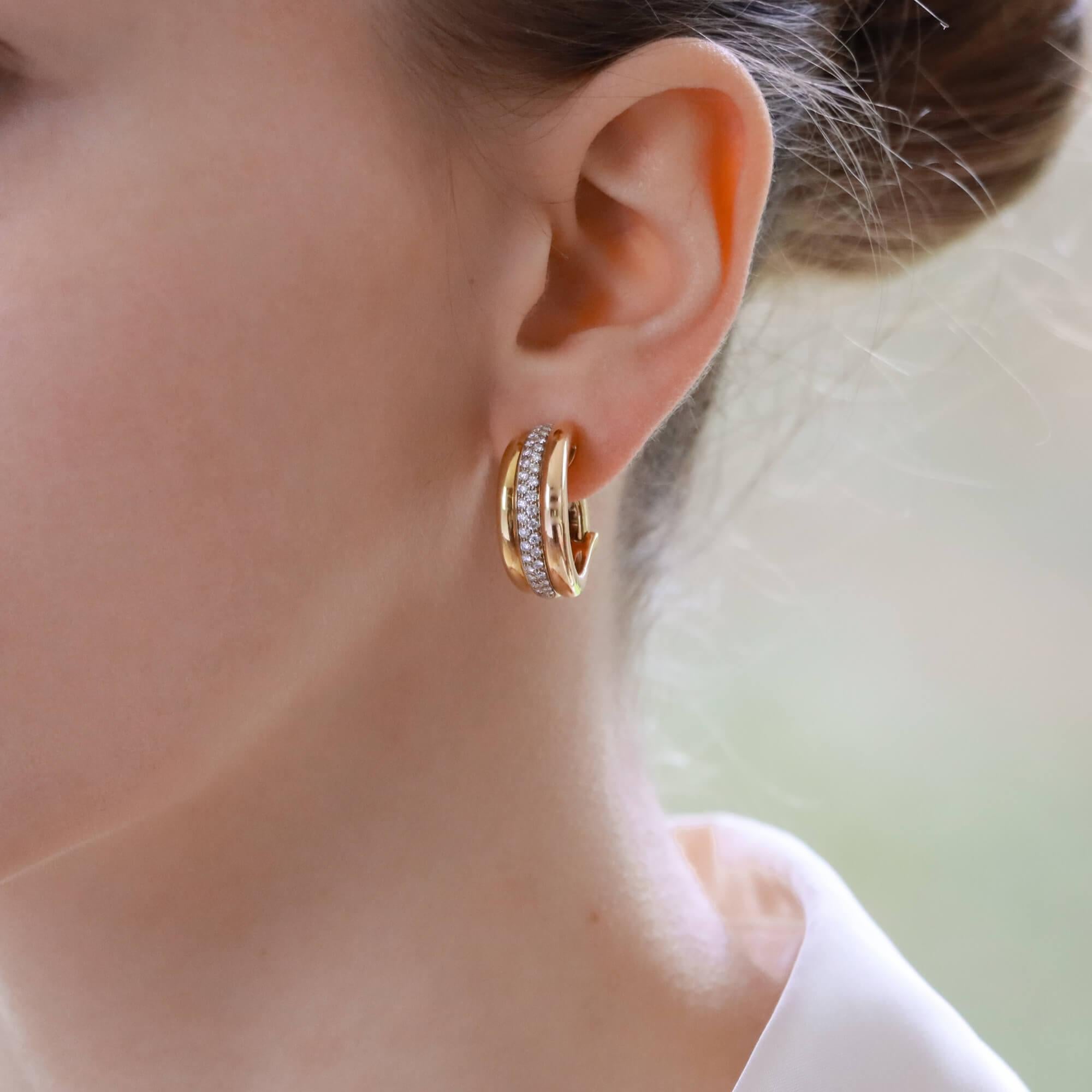 A beautiful pair of vintage Cartier diamond trinity hoop earrings set in 18k yellow, white and rose gold.

Each earring is designed in the classic trinity motif and are composed of 3 shouldered tri coloured gold bands. The central white gold band is
