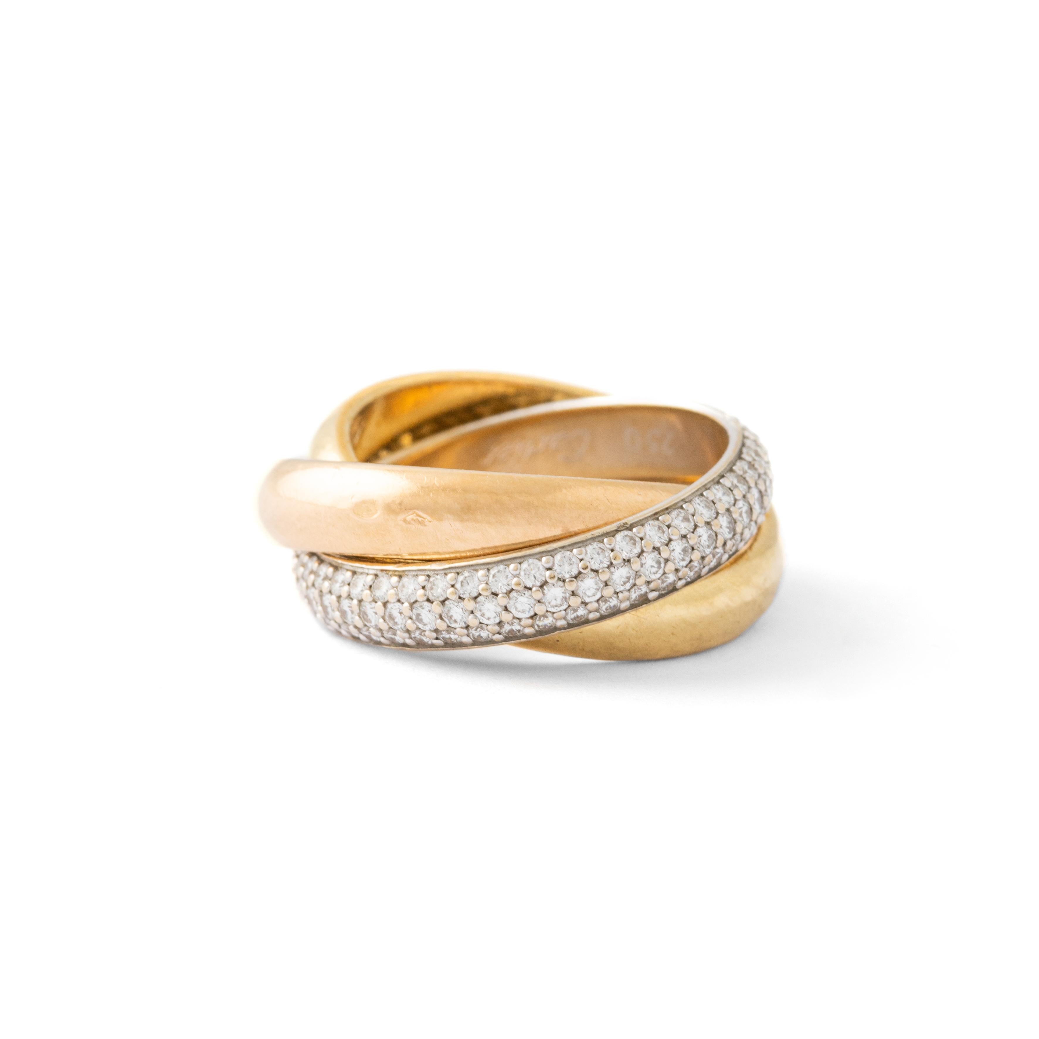 A classic Cartier diamond trinity ring set in 18k yellow, rose and white gold.

The ring is composed of three interlinked bands that are designed to roll with ease on the finger. The colour difference is subtle yet beautiful and the trinity is a
