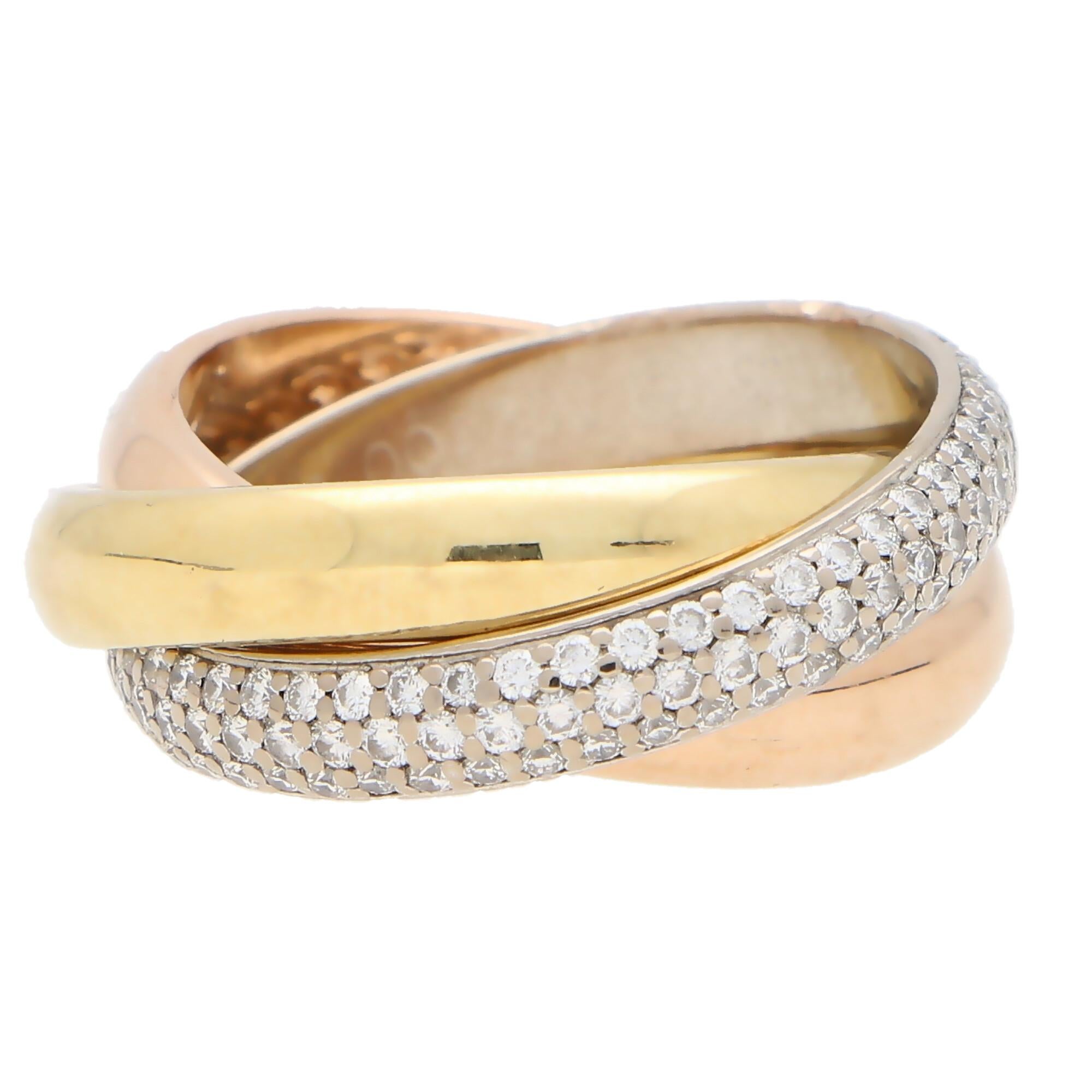 A classic Cartier diamond trinity ring set in 18k yellow, rose and white gold.

The ring is composed of three interlinked 4-millimetre bands that are designed to roll with ease on the finger. The colour difference is subtle yet beautiful and the