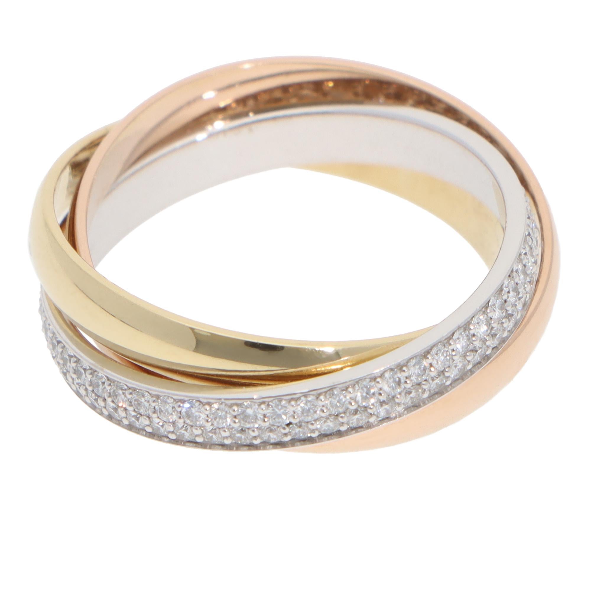 A classic vintage Cartier diamond Trinity ring small model set in 18k yellow, rose and white gold.

The ring is composed of three 2.8-millimetre bands, which are soldered together to create the hoop. It is designed to roll with ease on the finger.