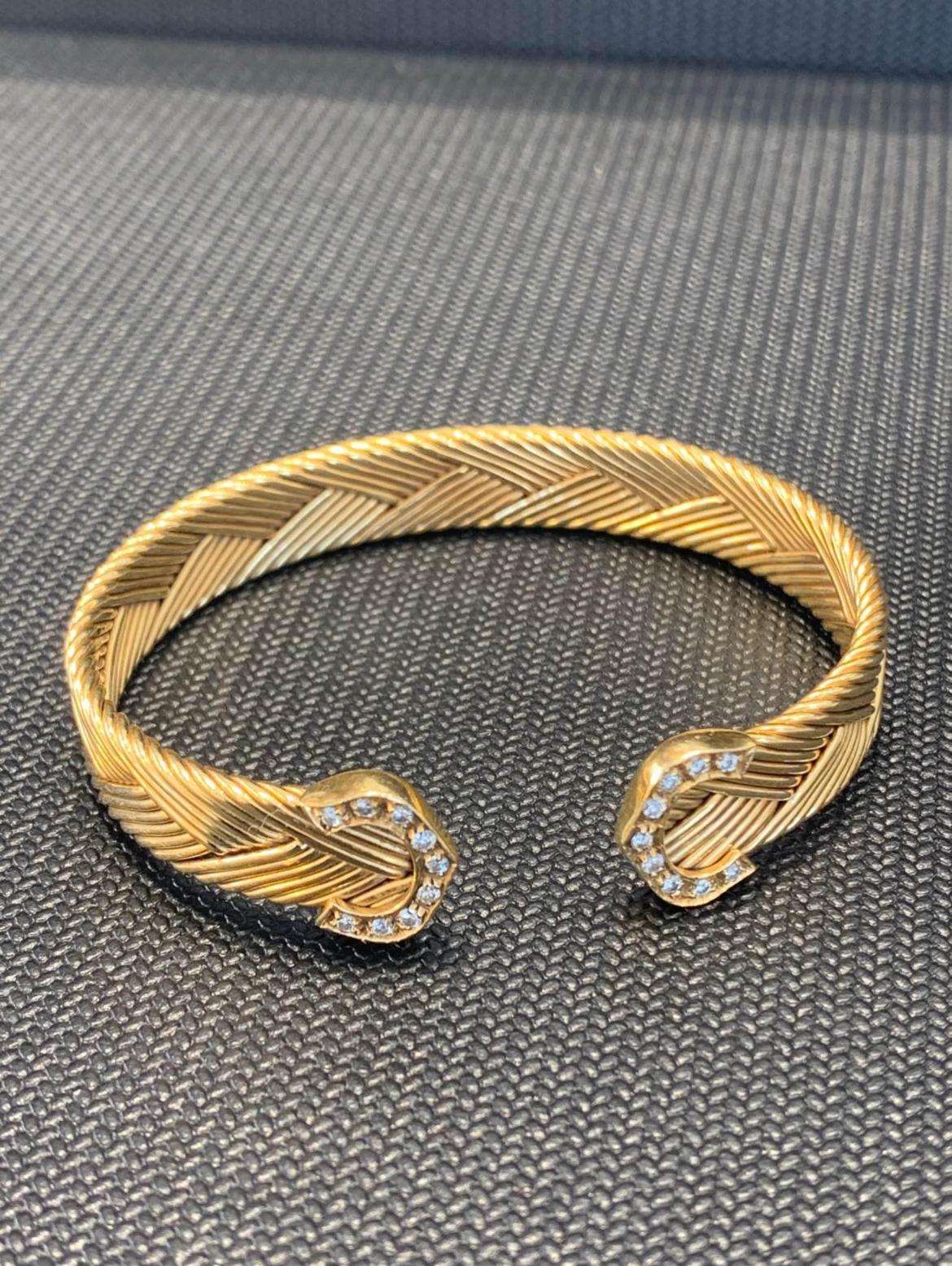 Beautifully Hand Crafted, 18k Solid Yellow Gold Weaved Cartier Neptune Bangle Bracelet, Set With Diamonds From Cartier.
Very Rare Cuff Bracelet.
Nice & Heavy!
Sits Very Comfortably On The Wrist.
Great Unisex Piece.
In Mint Condition.