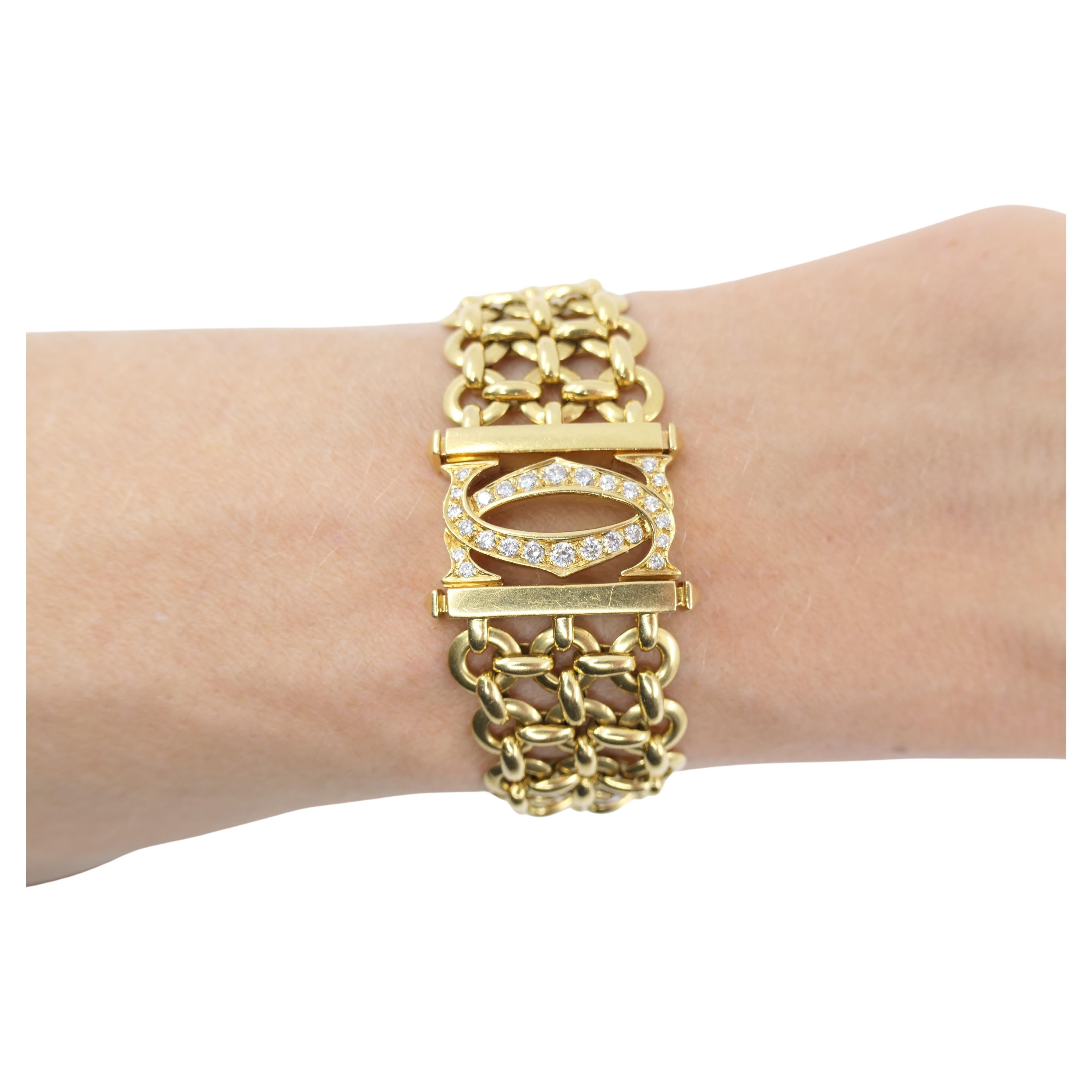 A vintage Cartier Double C 18k gold bracelet from Penelope collection. 
It's a mesh three-row link bracelet with a closure designed as the interlocking double C motif (the Cartier logo). The closure is a hidden push down clasp. 
The mesh comprises