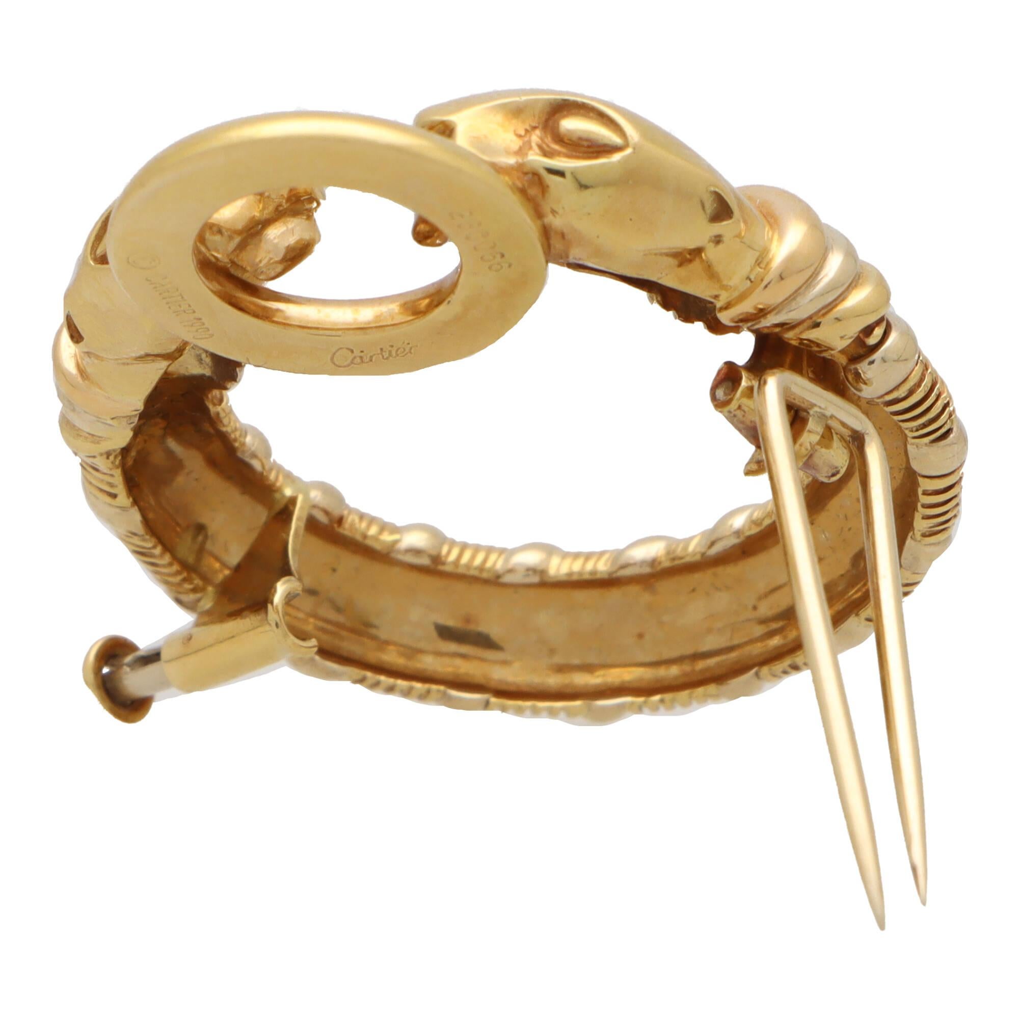 A beautiful vintage Cartier Panthère double headed brooch set in 18k yellow and white gold.

From a discontinued Cartier collection, the brooch depicts a double headed panther; both of which are grasping a polish yellow gold ring. The body of the