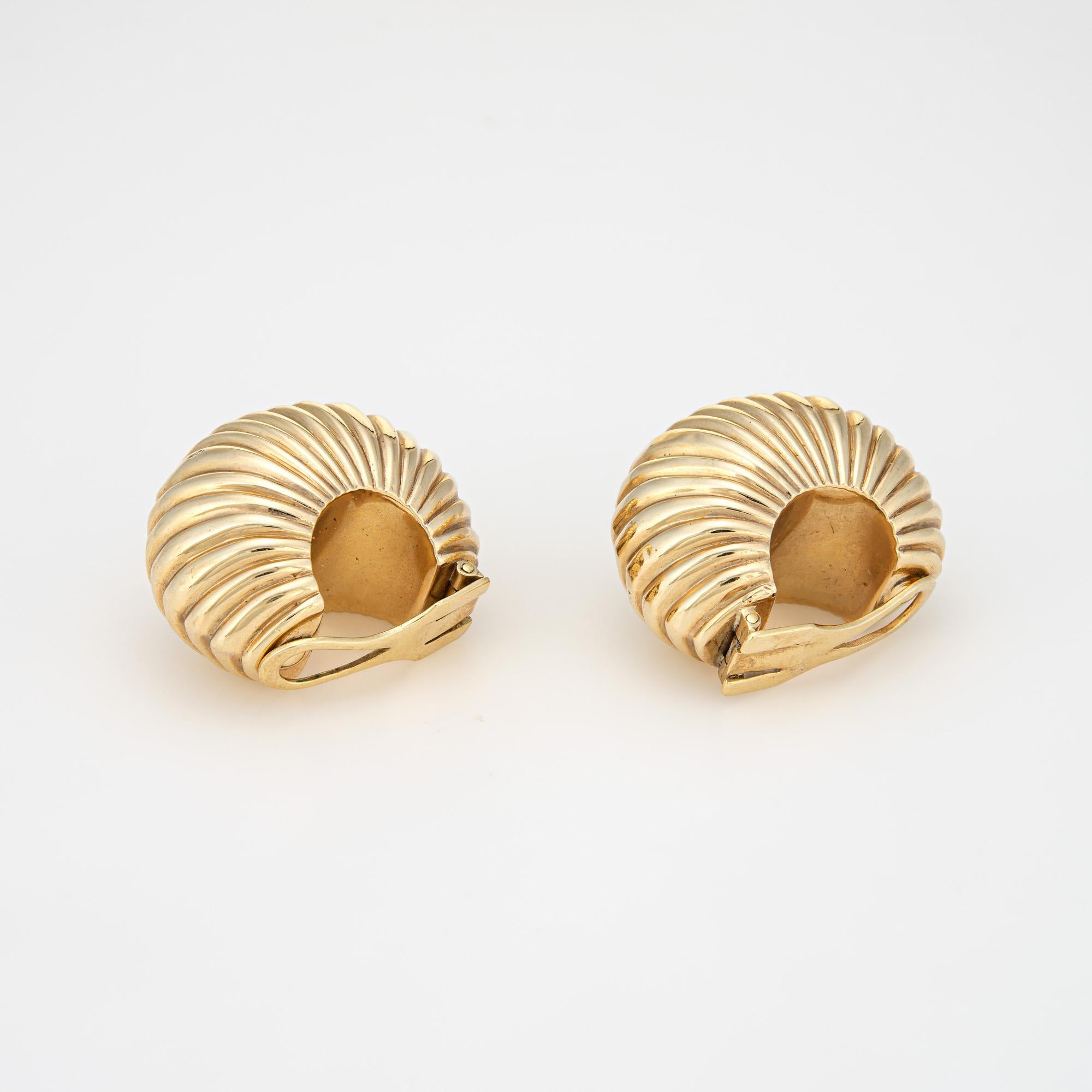Finely detailed vintage Cartier bombe cocktail earrings (circa 1945) crafted in 14 karat yellow gold. 

The stylish vintage earrings feature a fluted bombe design in a textured shell motif. The whimsical design of the earrings highlights the bold