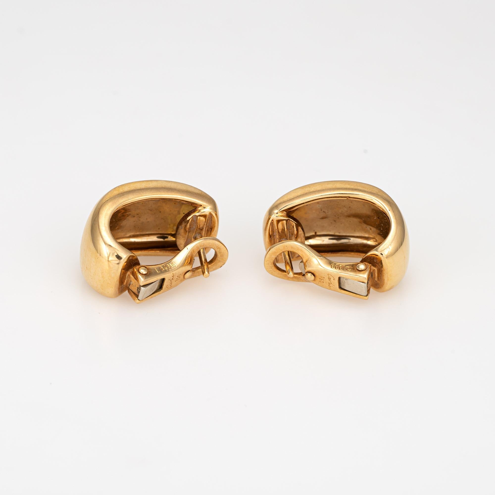 Out of production vintage Cartier 'Nouvelle Vague' earrings crafted in 18k yellow gold (circa 1999).  

The polished gold Cartier earrings measure 0.68 inches in length for a smaller shrimp style on the earlobe. The earrings are fitted with posts
