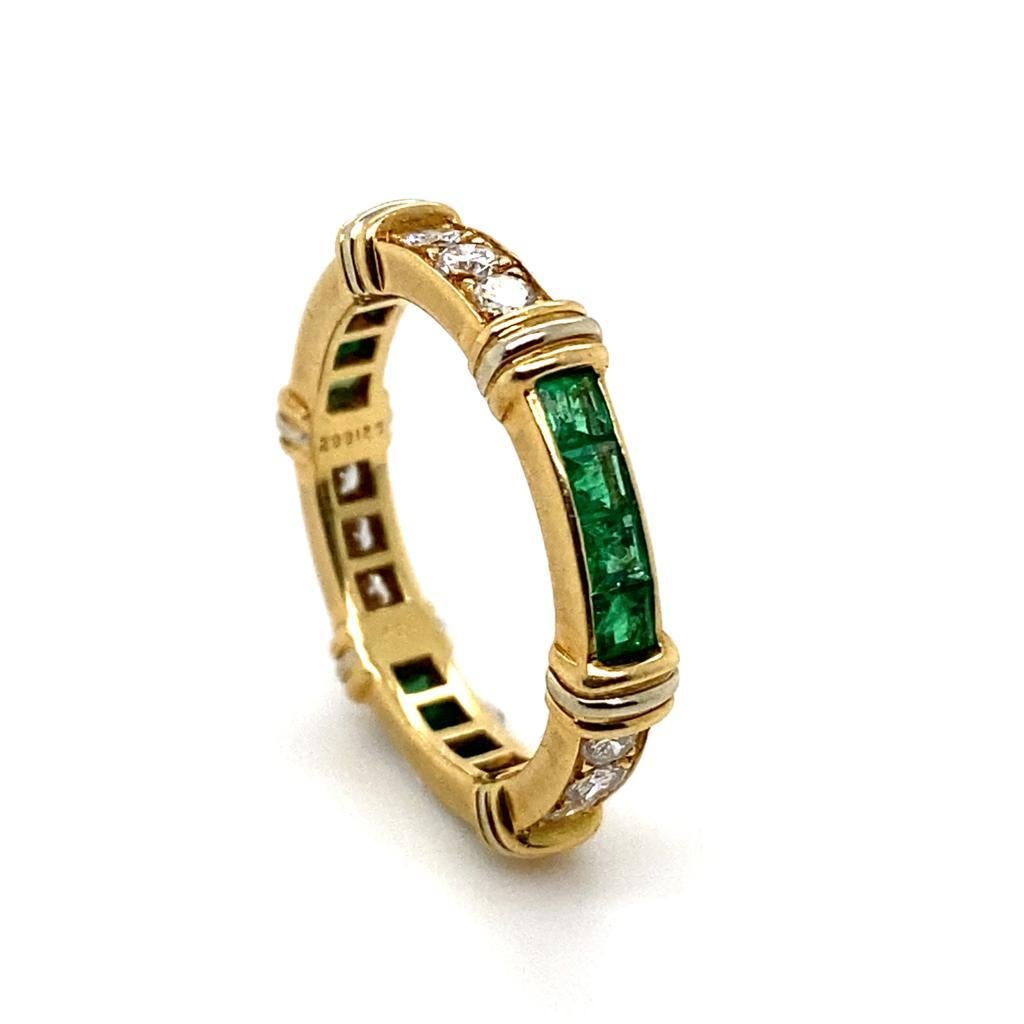 A vintage Cartier emerald and diamond 18 karat yellow gold full eternity ring, circa 1960.

A superb full eternity band, set with alternating calibré cut emeralds and round brilliant cut diamond sections.

The emeralds are a deep green colour, set
