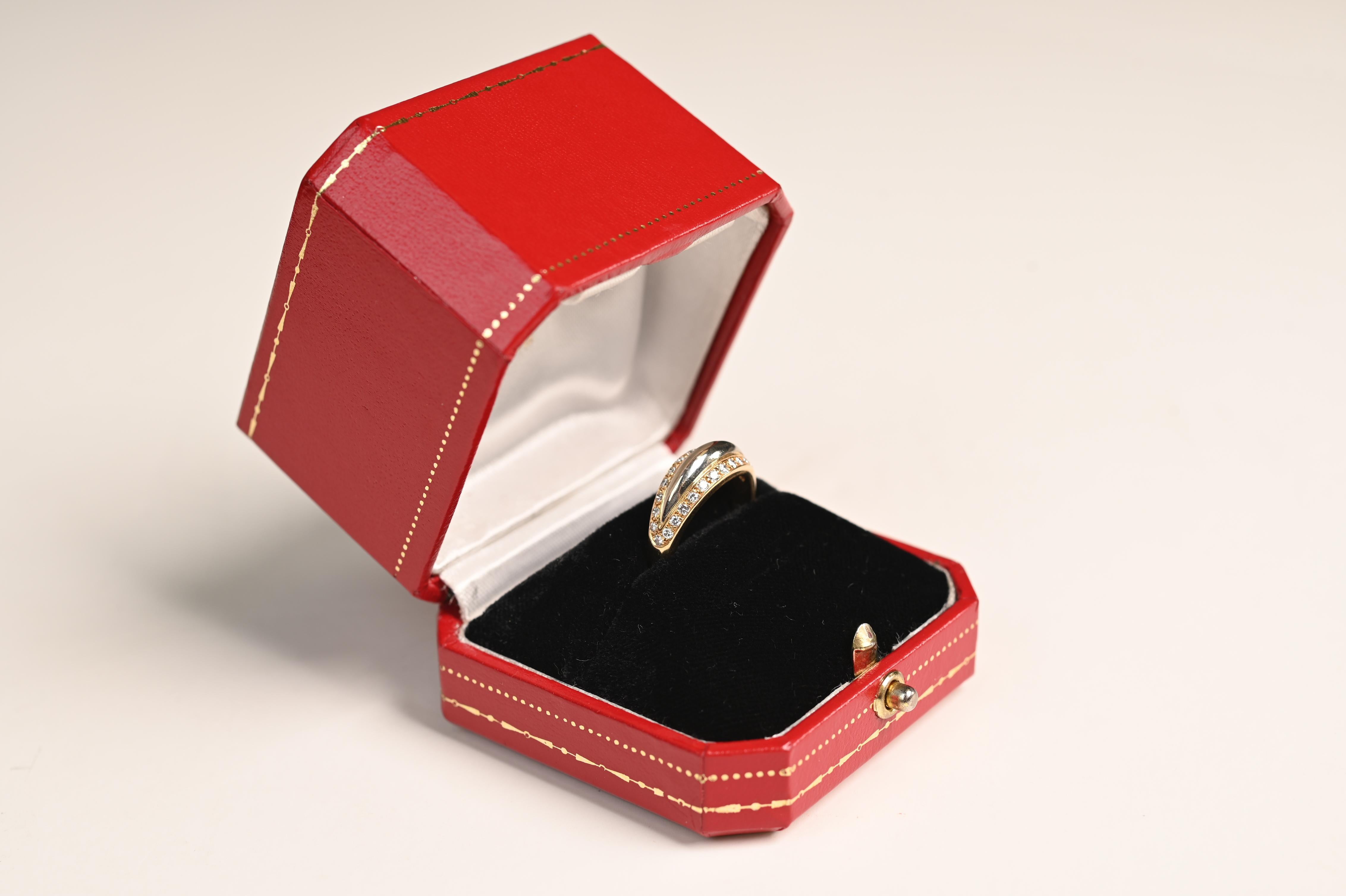 This exquisite vintage Cartier ring is a true testament to timeless luxury and craftsmanship. Meticulously handcrafted circa 1970, the ring showcases Cartier’s signature elegance in a striking combination of 18k white and yellow gold. Its