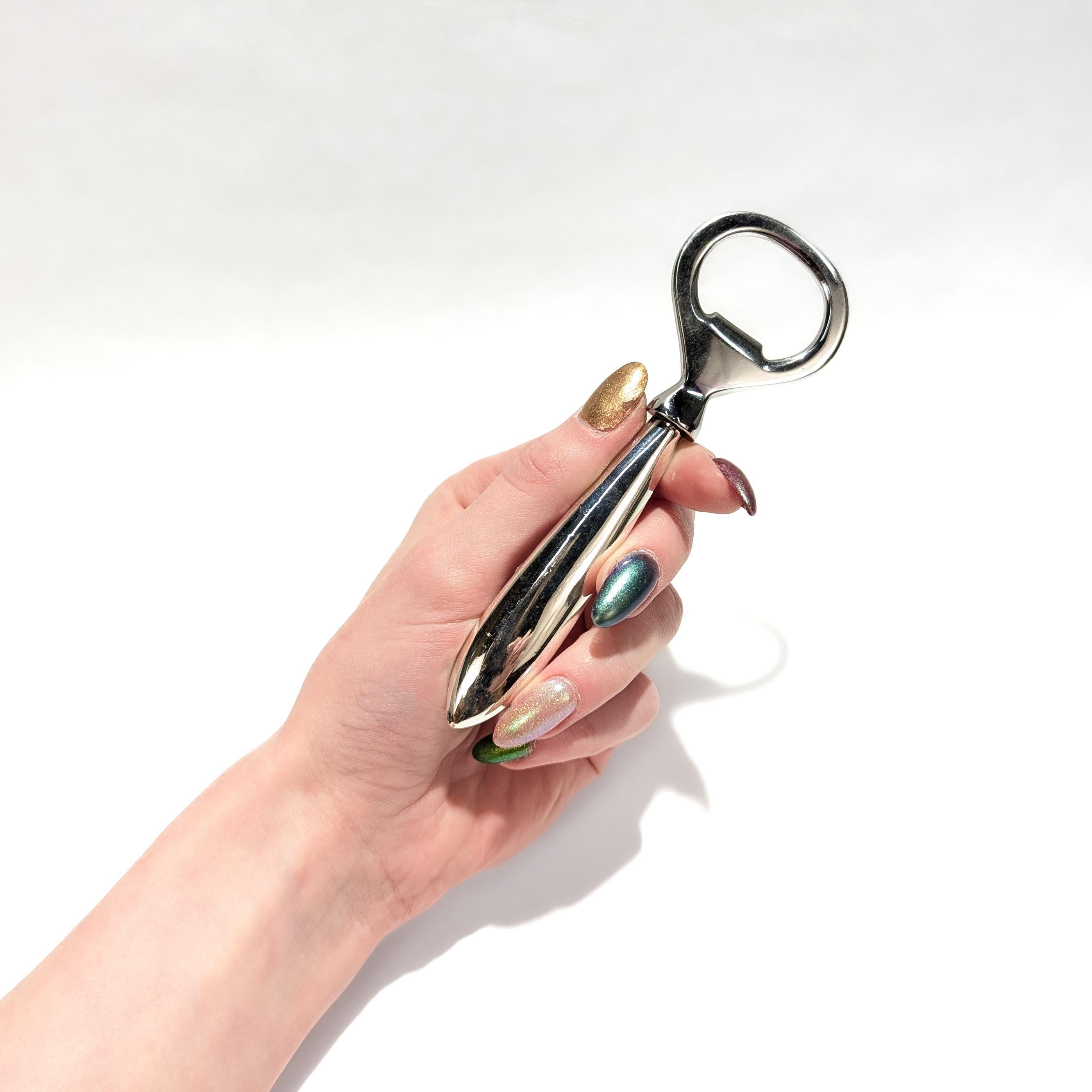 A fine vintage French sterling silver bottle opener.

In sterling silver.

By Cartier.

With an engraved bottle to one side of the handle.

With a filled handle and a stainless steel top.

Simply a wonderful Mid-Century Modern Cartier bottle