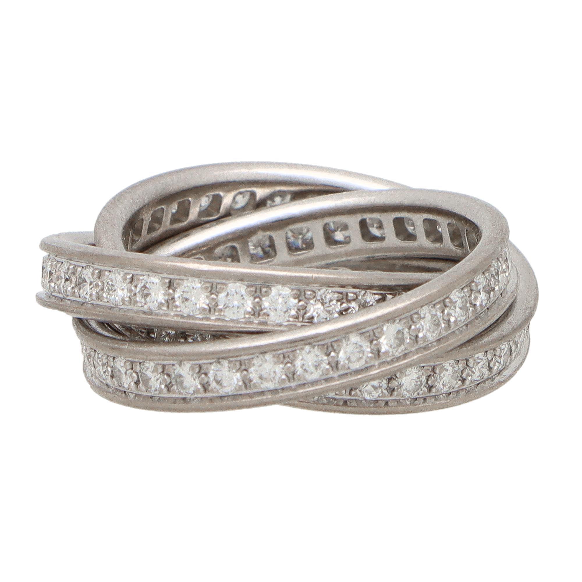 A classic Cartier diamond trinity ring set in 18k white gold.

The ring is composed of three interlinked 3.5-millimetre bands that are designed to roll with ease on the finger. All of the bands are completely set with round brilliant cut diamonds