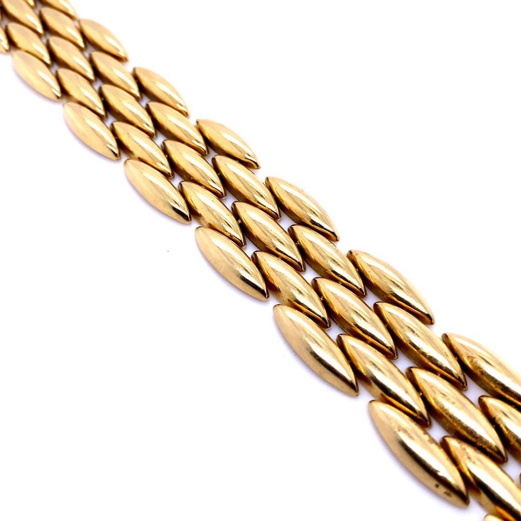 Cartier yellow five row bracelet, circa 1990

A rare retro bracelet from Cartier's elegant Gentiane collection.

The bracelet is comprised of five rows each segment designed as an elongated lozenge shape crafted in 18 karat yellow gold with a fine