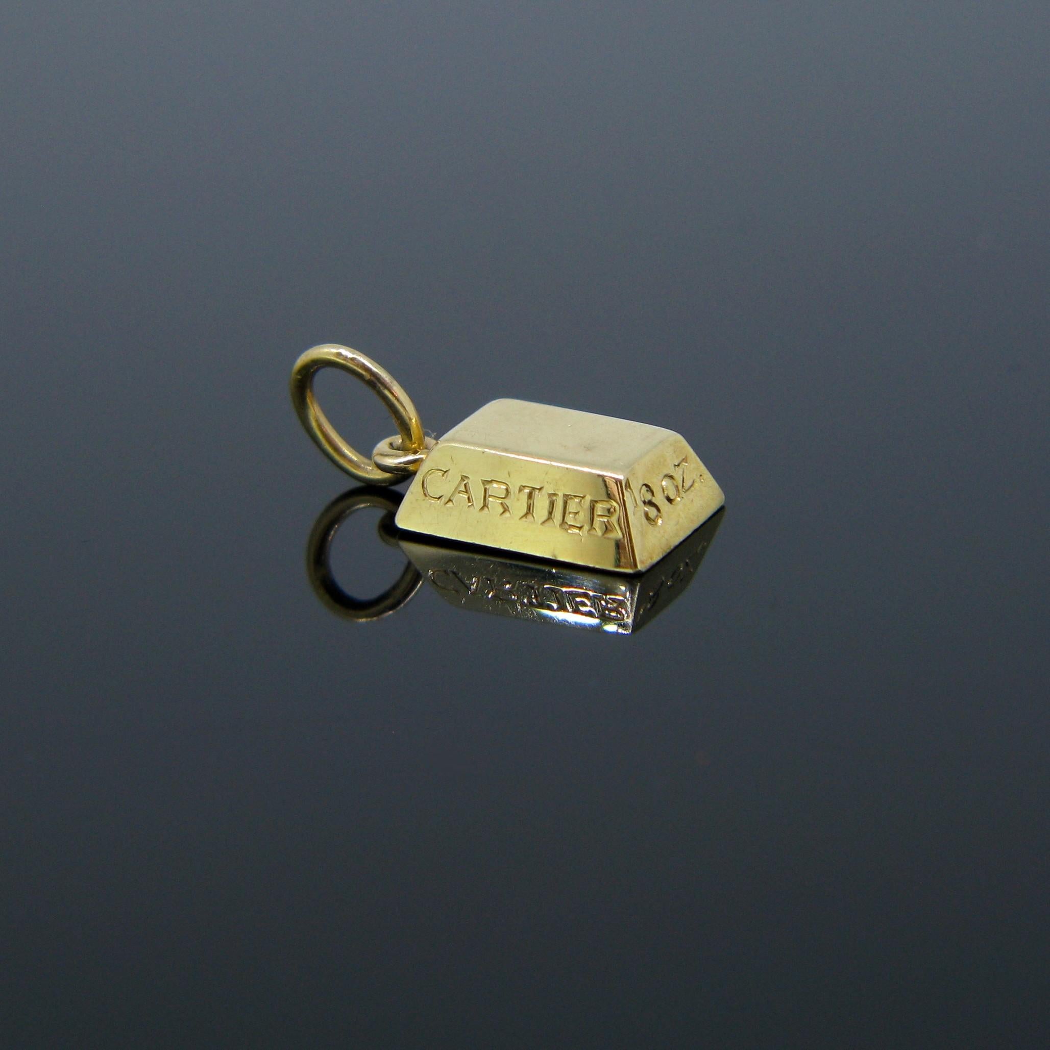 This pendant signed Cartier is a 1/8 ounce gold bar or ingot. It is fully made in 18kt yellow gold. It is signed Cartier at the back. It is also engraved with Cartier on one of the sides.

Weight:	4.2gr


Metal:		18kt Yellow Gold


Condition:	Very