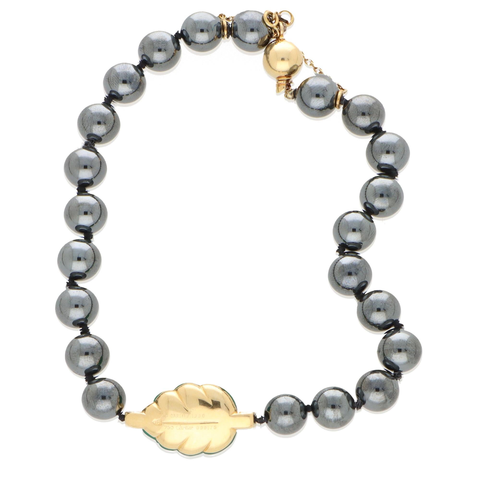A truly beautiful vintage Cartier hematite, chalcedony and diamond beaded bracelet set in 18k yellow gold. 

The bracelet is composed of 22 round hematite beads which have a fantastic striking metallic lustre. Set centrally to the bracelet is a