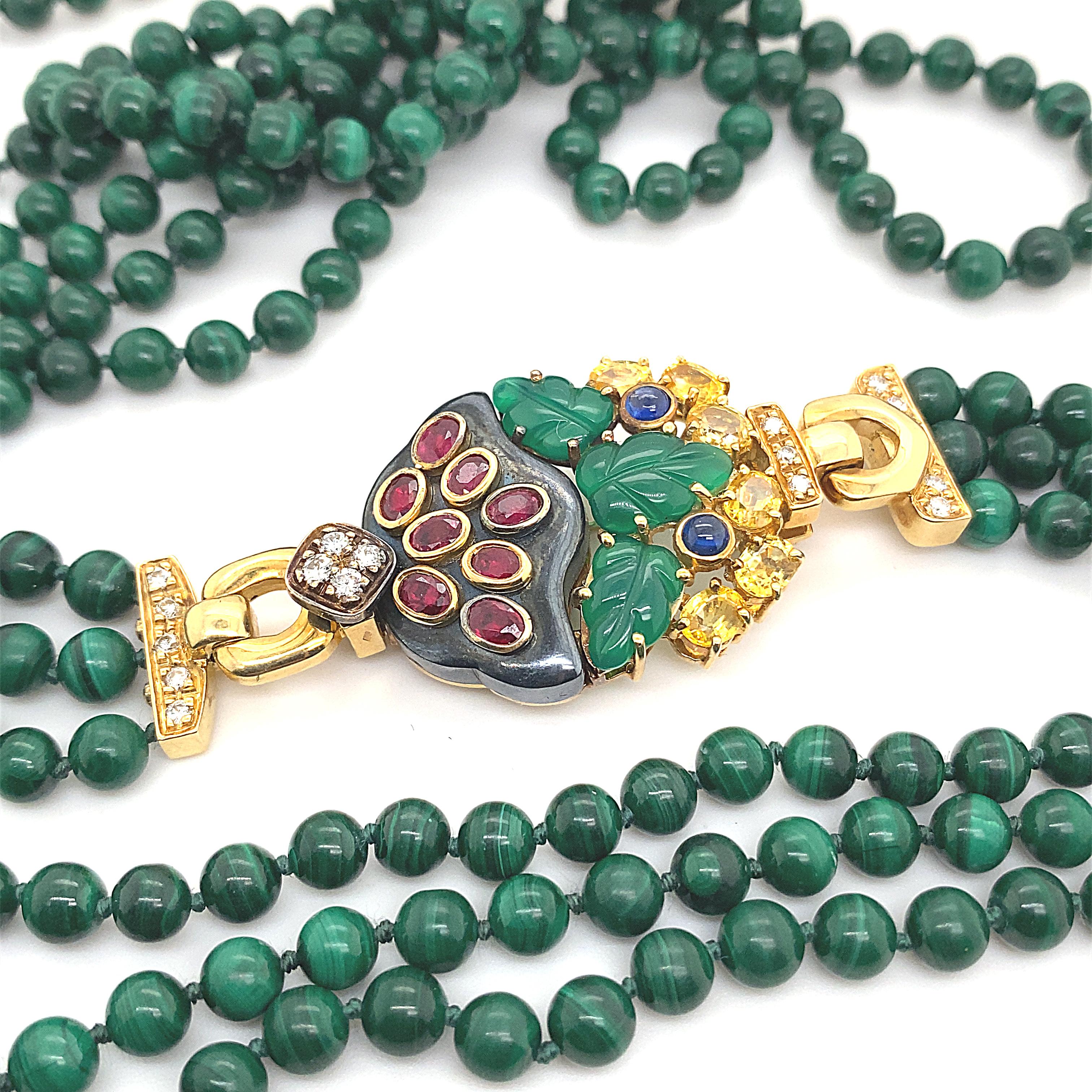 A vintage Cartier hematite, chalcedony, ruby, sapphire, malachite and diamond necklace, circa 1990.

This exceptional malachite three row bead sautoir necklace in 18 karat yellow gold features a flower pot shaped brooch, crafted in hematite with a
