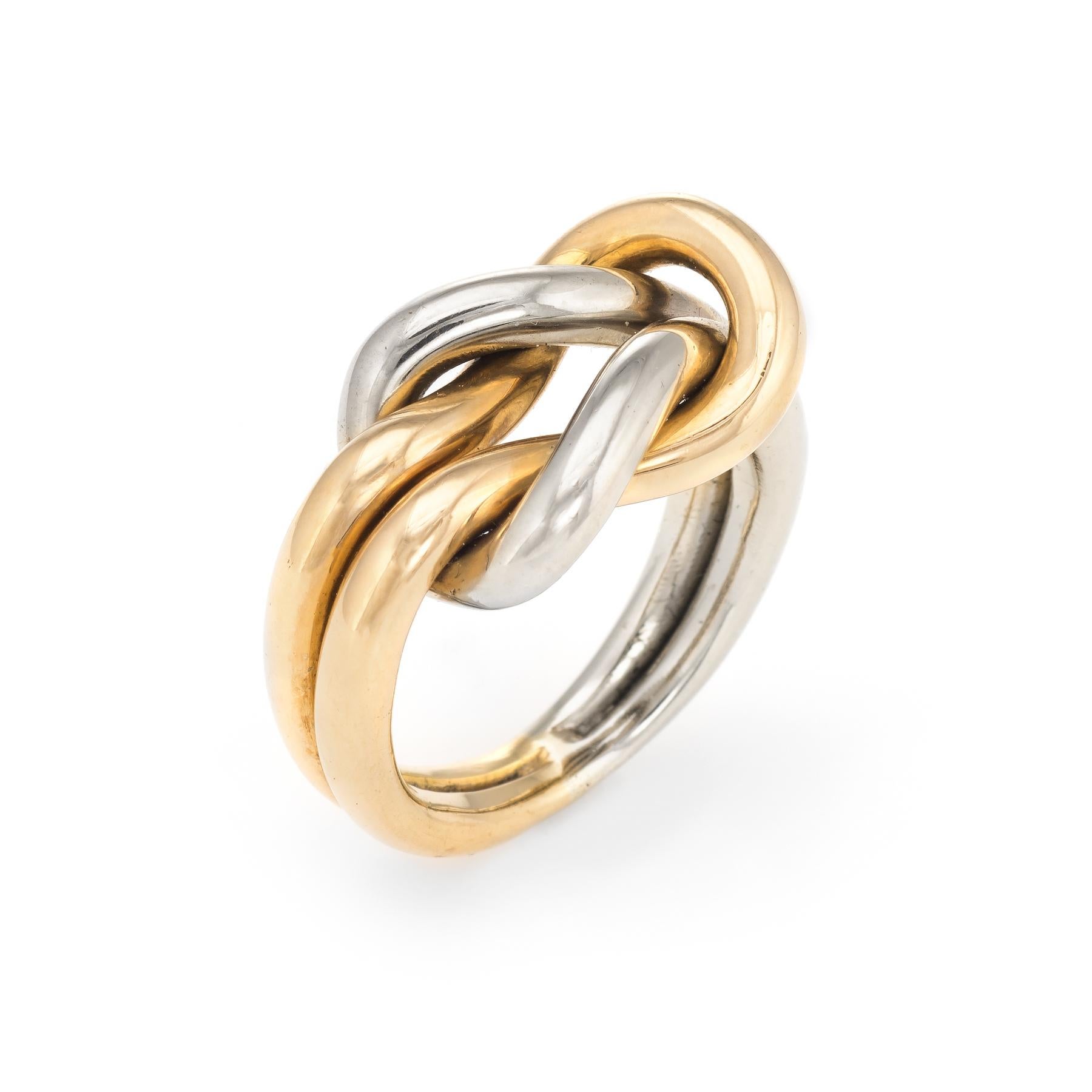 Vintage Cartier Hercules knot ring, crafted in 18 karat yellow & white gold.  

The ring is no longer available for sale at retail.

The ring is in excellent condition. 

Particulars:
Weight: 13.5 grams

Stones:  N/A

Size & Measurements: The ring