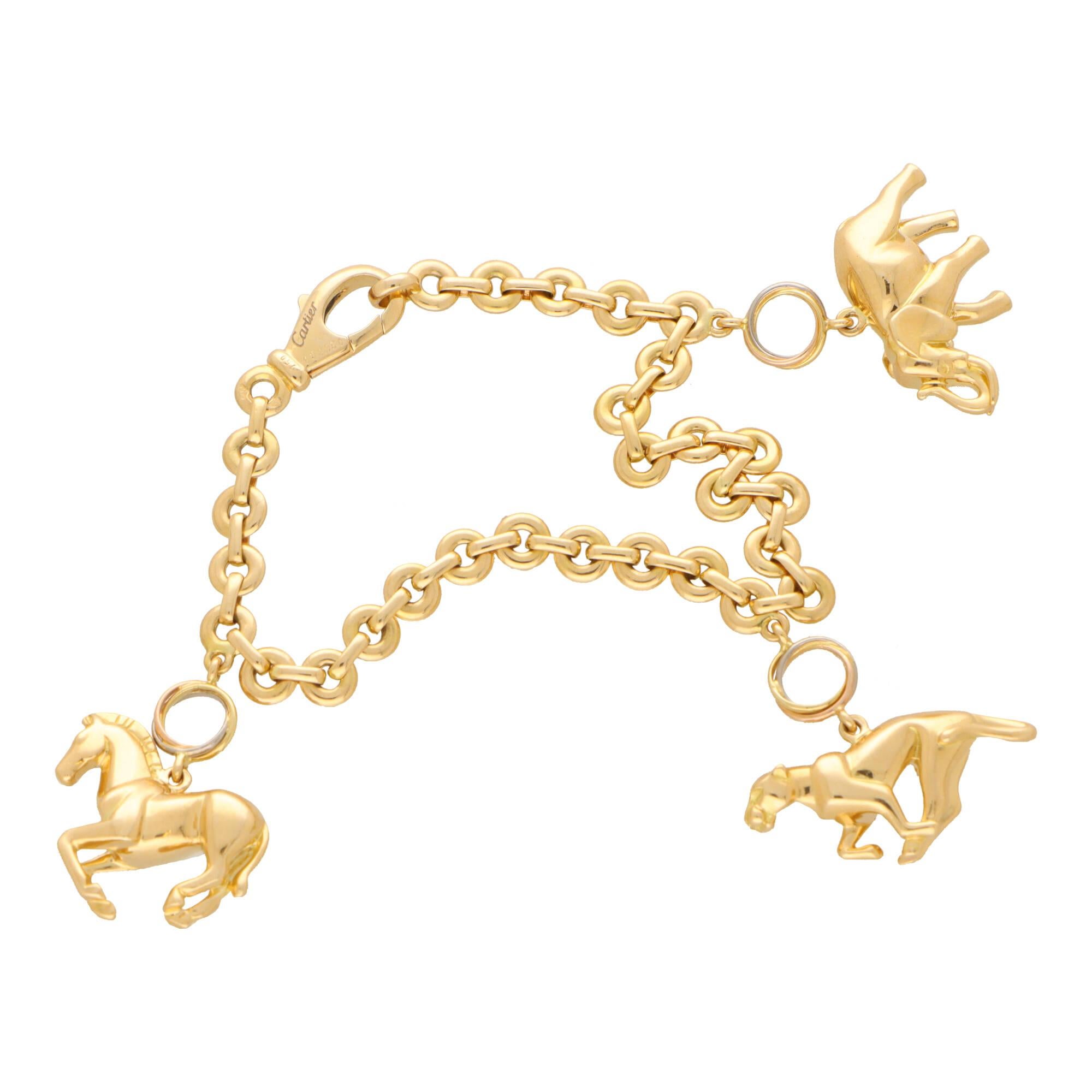 A beautiful vintage Cartier charm bracelet set in 18k yellow gold.

The piece is firstly composed of an elegant link bracelet, fastened with a secure lobster clasp with the Cartier hallmarking engraved to one side. From this link bracelet hangs
