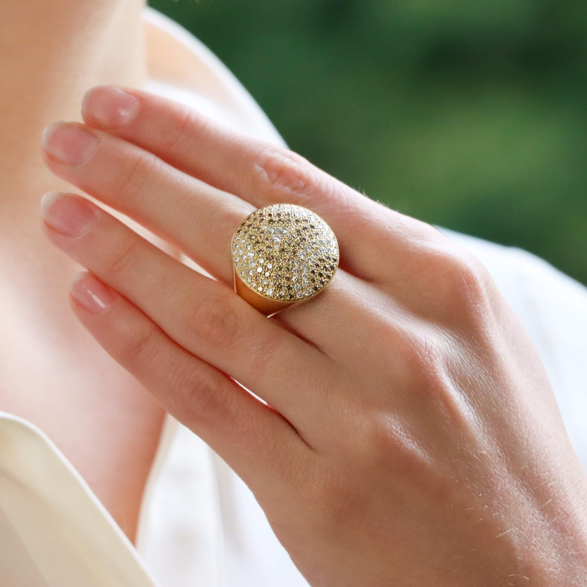 An extremely beautiful Cartier white and cognac diamond cocktail ring, from the Jeton Sauvage collection, set in 18k yellow gold.

This unique looking piece is pave set throughout with 52 white and 68 cognac round brilliant cut diamonds which create