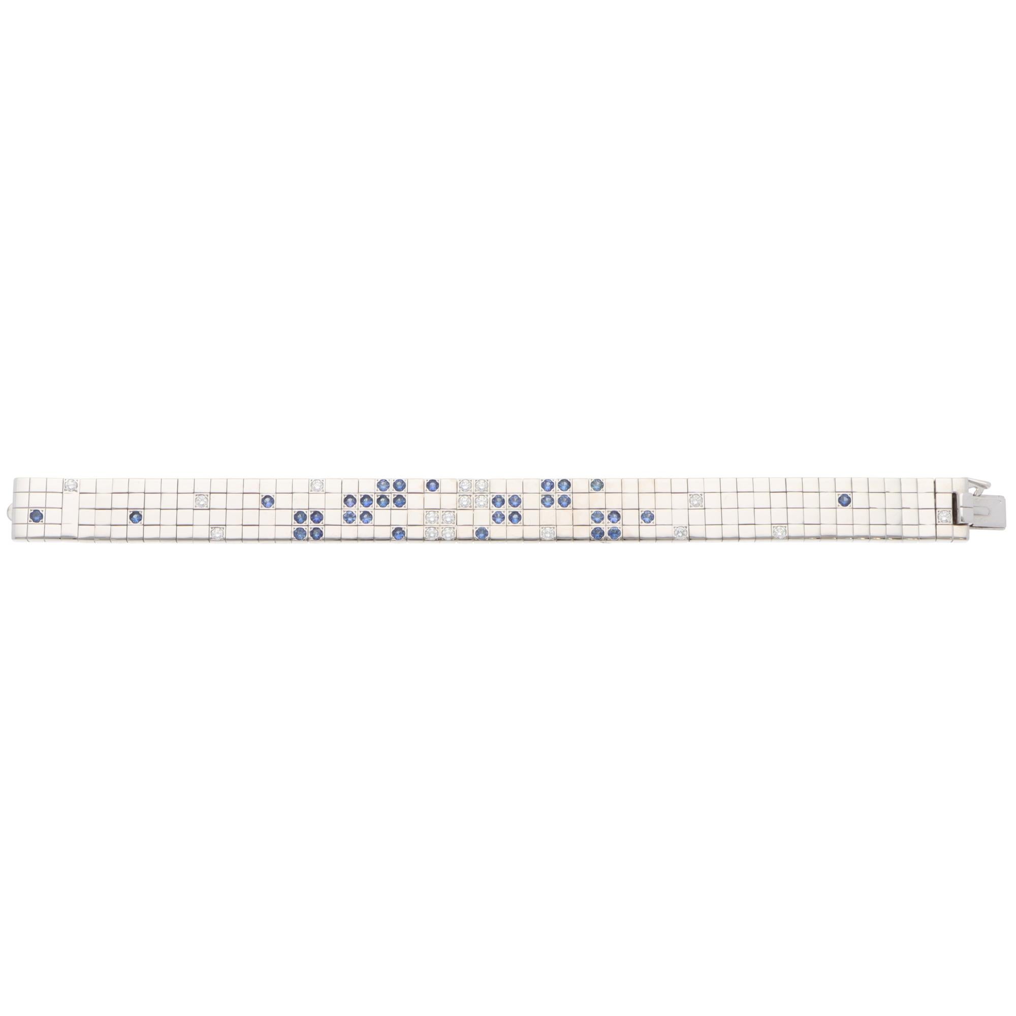 A beautiful vintage Cartier Lanières blue sapphire and diamond bracelet set in 18k white gold.

From Cartier's discontinued collection, the bracelet is composed of solid yellow gold flat links set with 33 vibrant blue sapphires and 17 round