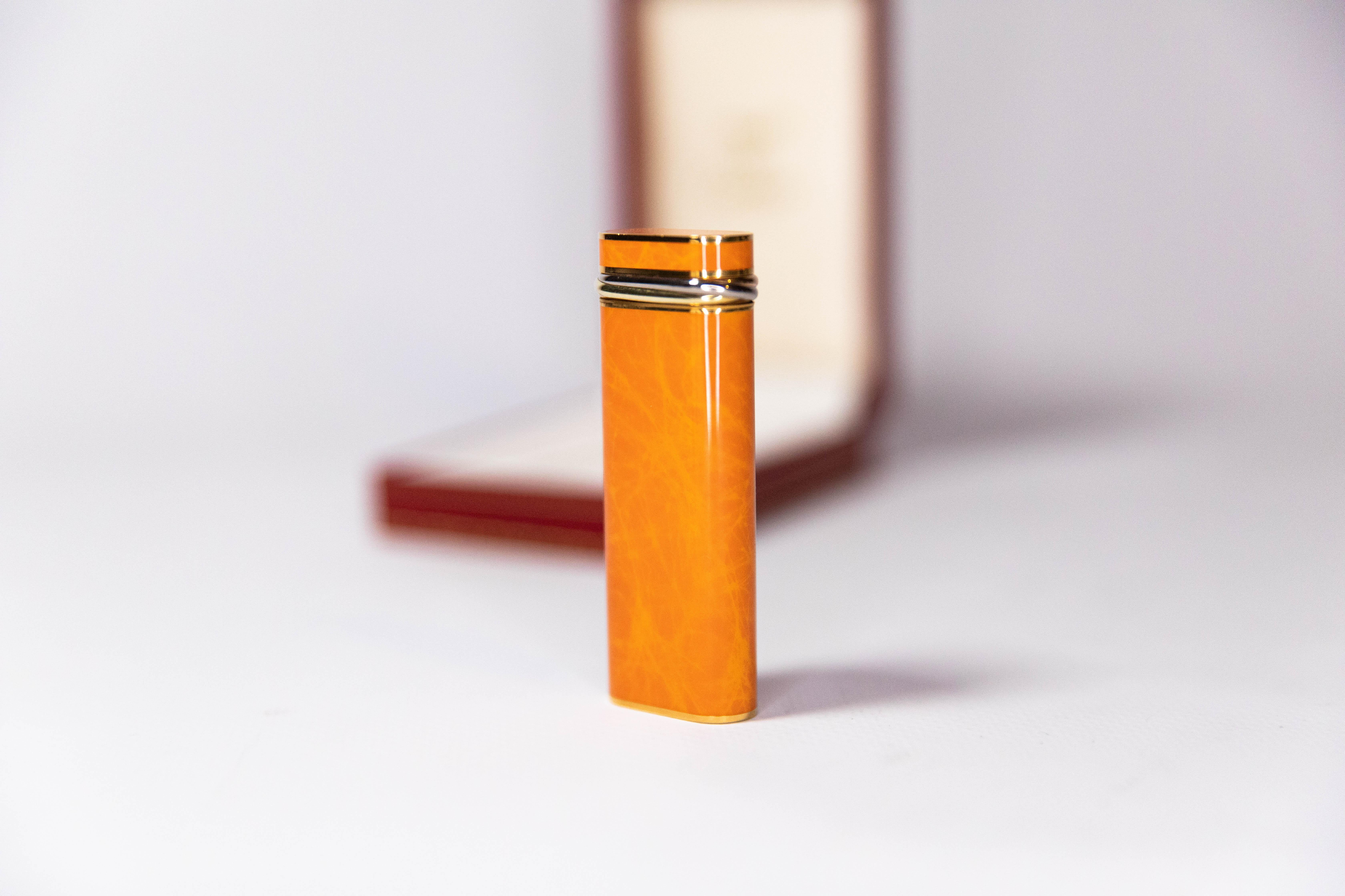 Women's or Men's Vintage Cartier Les Must Trinity lighter Gold Plated with Orange Laquer For Sale