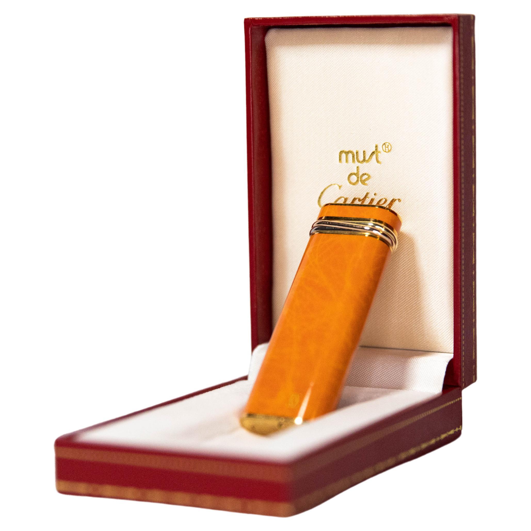 Vintage Cartier Les Must Trinity lighter Gold Plated with Orange Laquer For Sale
