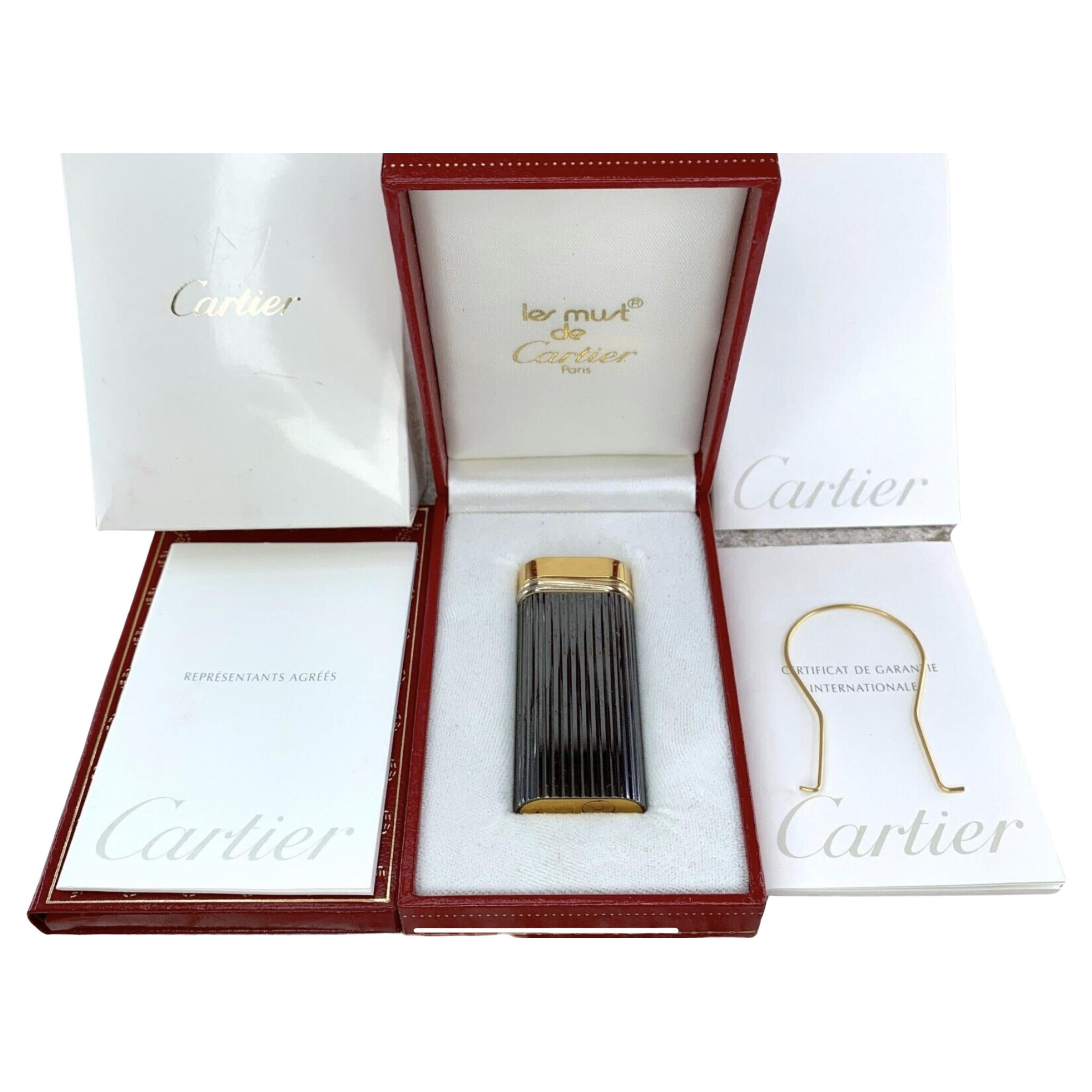 Vintage Cartier Lighter Short “Trinity” Rare Gunmetal and Gold 
“Godron” Model 
Trinity collection 
18K gold ring 
Gunmetal 
Lighter comes fully loaded :)
Original Cartier certificate 
Lint 
Original Cartier papers 
Original Cartier Red Case