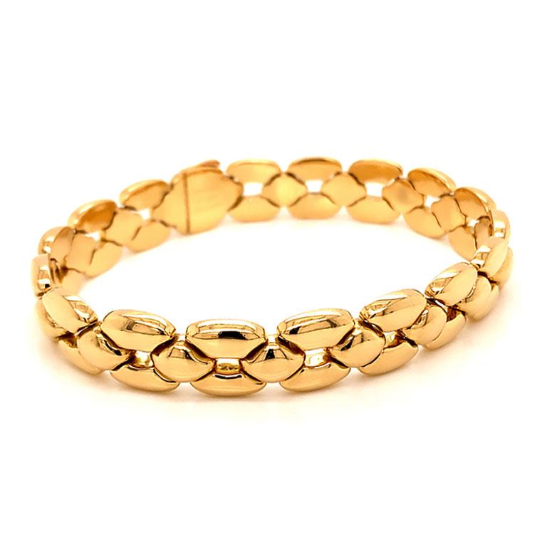 Authentic Vintage Cartier link bracelet from 1992. Beautifully made with geometric designs in 18k yellow gold. The bracelet is 12.30 mm wide and 8 inhes long. The bracelet has a slide in box clasp with an additional side hook clasp for extra