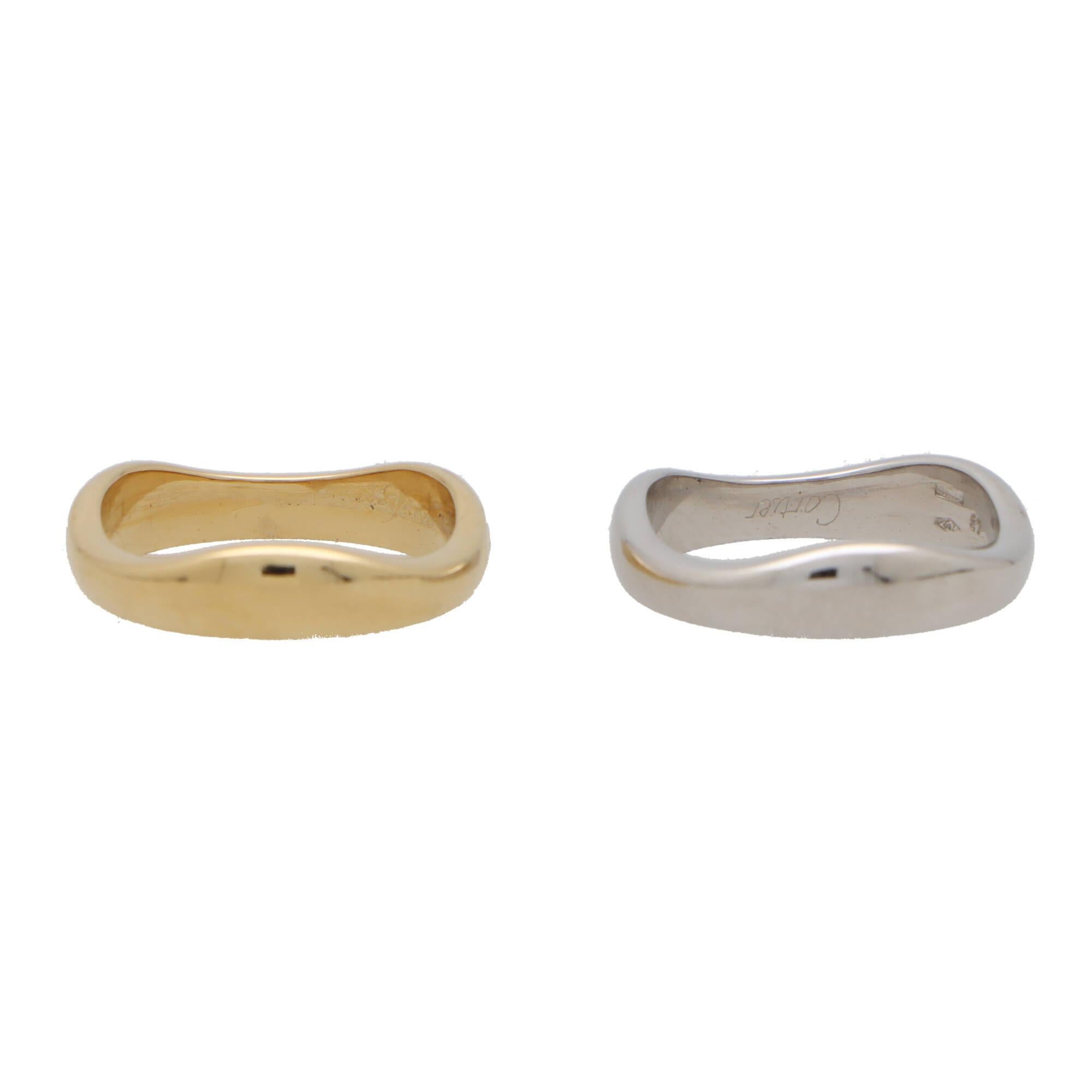 A beautiful Cartier 'Love Me' band ring set in 18k yellow and white gold. 

The ring is composed of two 5-millimetre bands carved to perfectly fit together. The ring can easily be worn for every day as a standalone piece, or alternatively, stacked