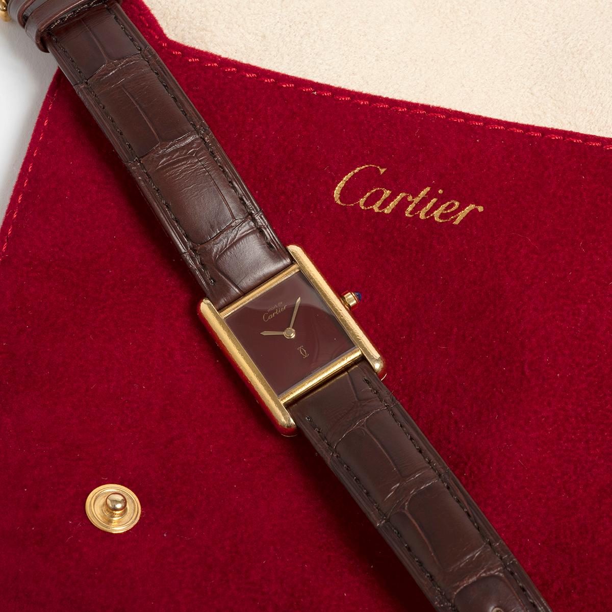 An icon of the 1980s, our vintage Cartier Must De Cartier Tank ref 3660 with quartz movement features a heavy gold plated vermeil silver case , Cartier burgundy dial, gilt hands, a new Cartier burgundy leather strap (with no wear) and gold plated