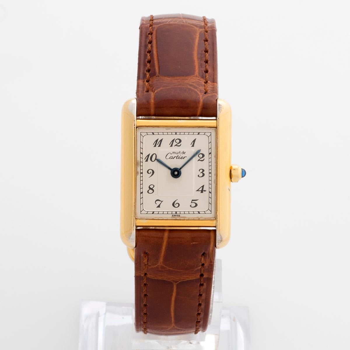 Our vintage and rare Cartier Must De Cartier Tank features a 20mm x 28mm (excluding crown) case of sterling silver with heavy gold plating (vermeil) which is in excellent condition for its age with some deterioration to the plating. A new Cartier