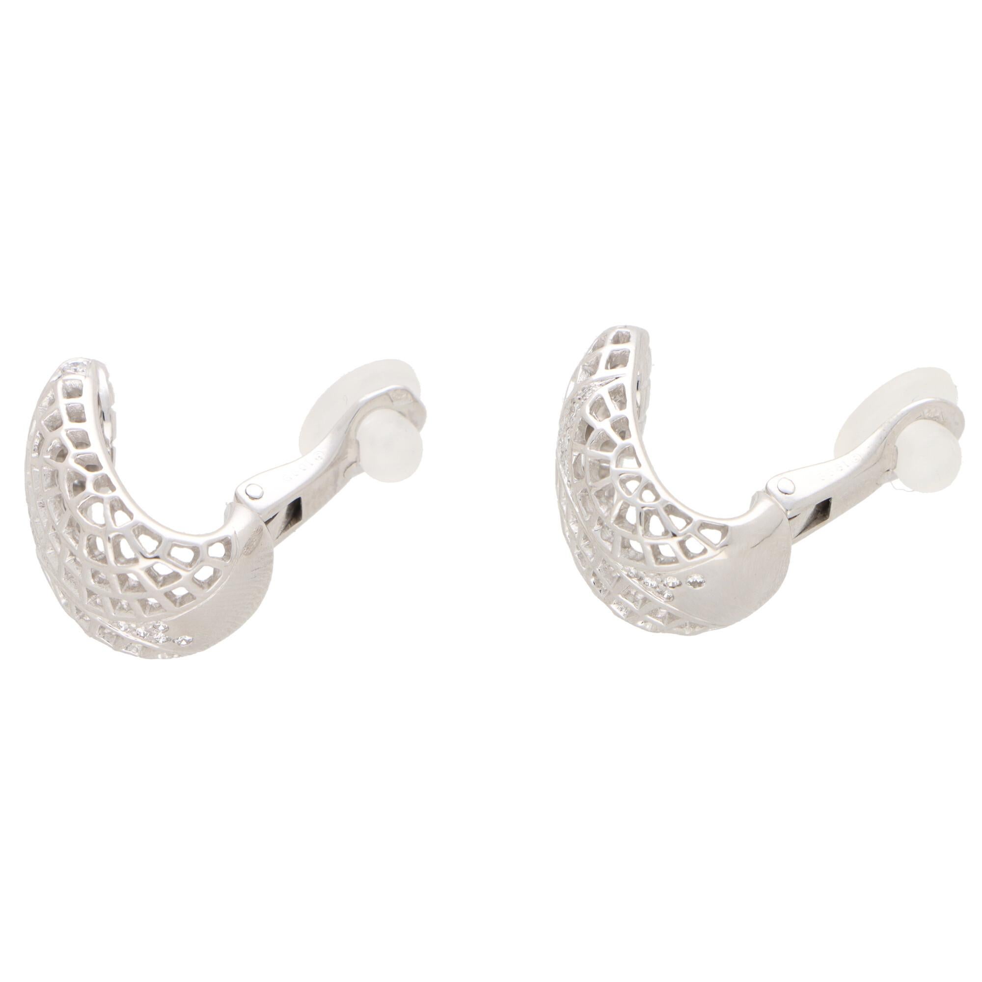  A beautiful pair of vintage of Cartier Nouvelle Vague earrings set in 18k white gold.

From the now discontinued Nouvelle Vague collection, the earrings are each composed of a geometric webbed design. Each earring is set with nine round brilliant