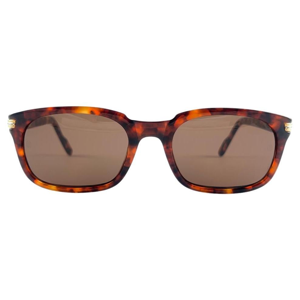 Mint Cartier Panama in tortoise with light brown (uv protection) lenses. 
Frame is tortoise and has the famous real gold and white gold accents. All hallmarks. 
These are like a pair of jewels on your nose with the 18k heavy gold plated accents.