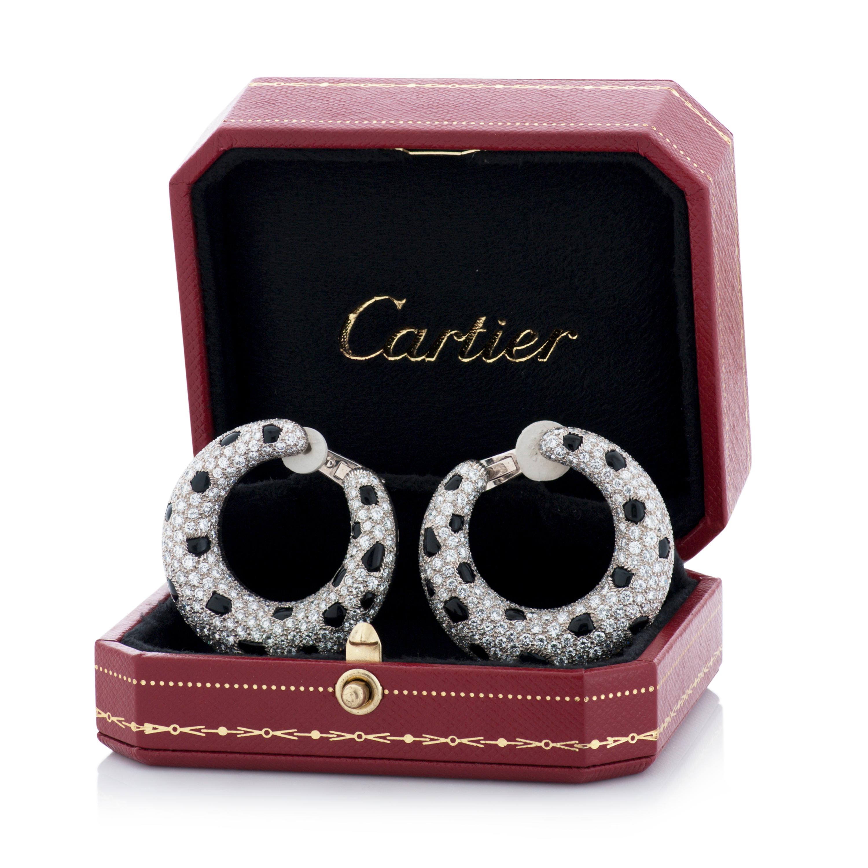 Vintage Cartier Panthere diamond and onyx hoop earrings in 18k white gold, accompanied by original Cartier box.

This pair of Cartier earrings feature approximately 9.42 carats of pave set round brilliant cut diamonds with E-F color and VS clarity,