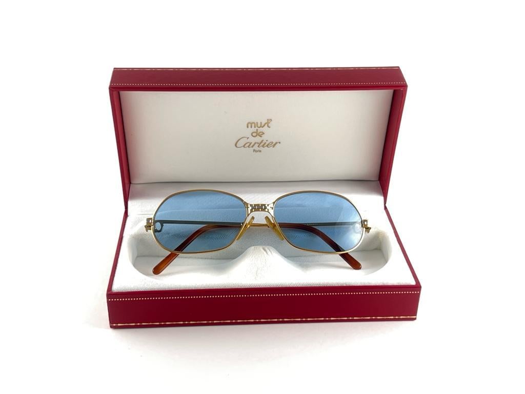 1988 Cartier Panthere GM sunglasses with light blue  (uv protection) lenses. Frame is with the front and sides in yellow and white gold. All hallmarks. burgundy ear paddles. 
Both arms sport the C from Cartier on the temple. 
These are like a pair