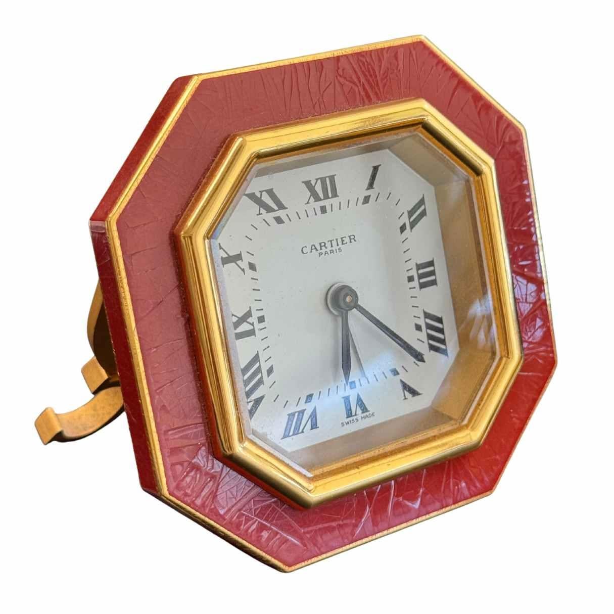 Cartier Paris table alarm clock, manual winding
Made in Switzerland approximately 1980
Gold plated brass case
Enamel detail around the frame, shows some wear consistent with age
Hallmarks: Cartier Paris 7507 09306 Swiss Made
Weight: 340.3