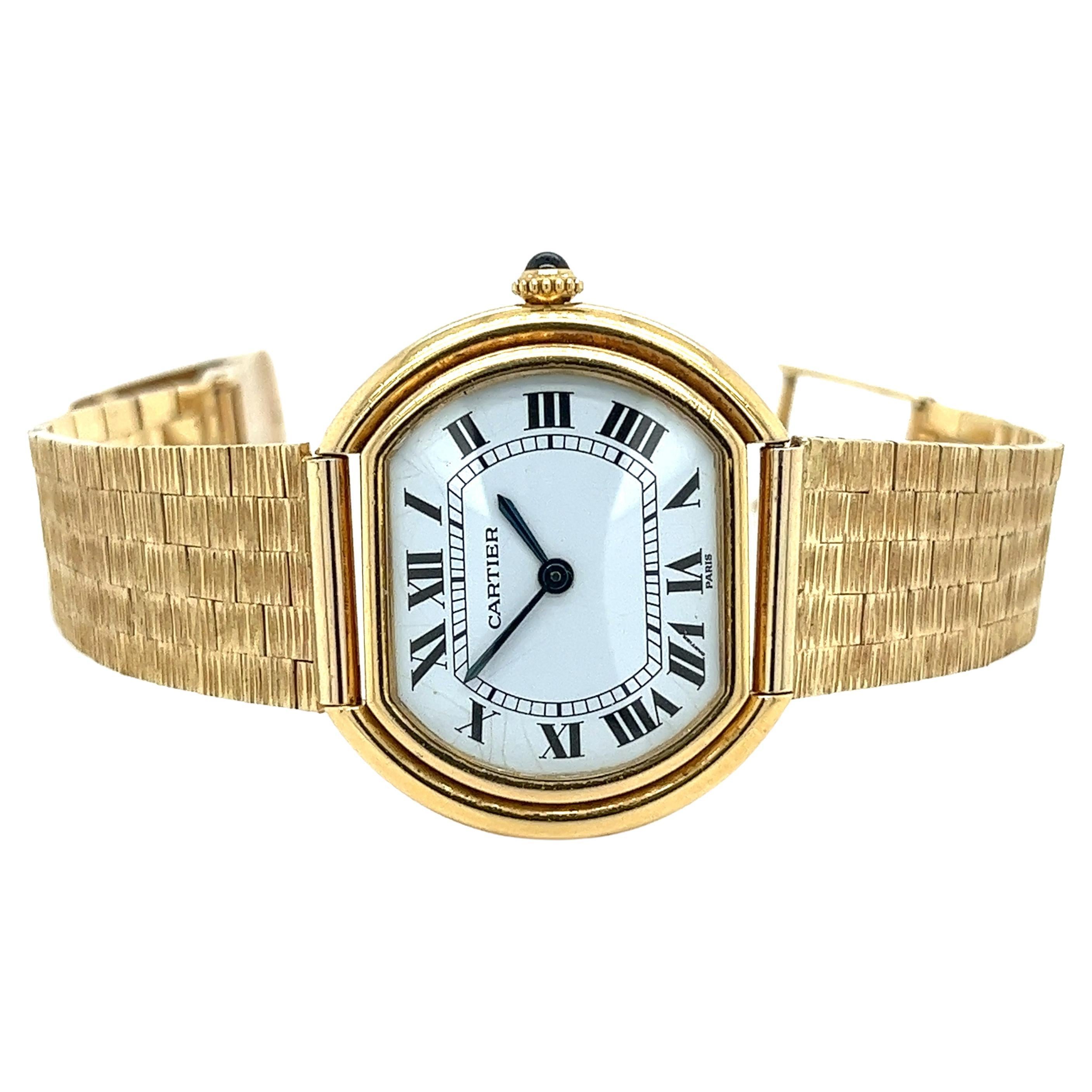 Vintage Cartier Paris 18k gold ladies watch with a Roman numeral dial and the classic Cartier style blue sword-shaped hour markers. Manual wind movement with a screw-down crown and sapphire crystal. 

The bracelet is made by Lucien Piccard, part of