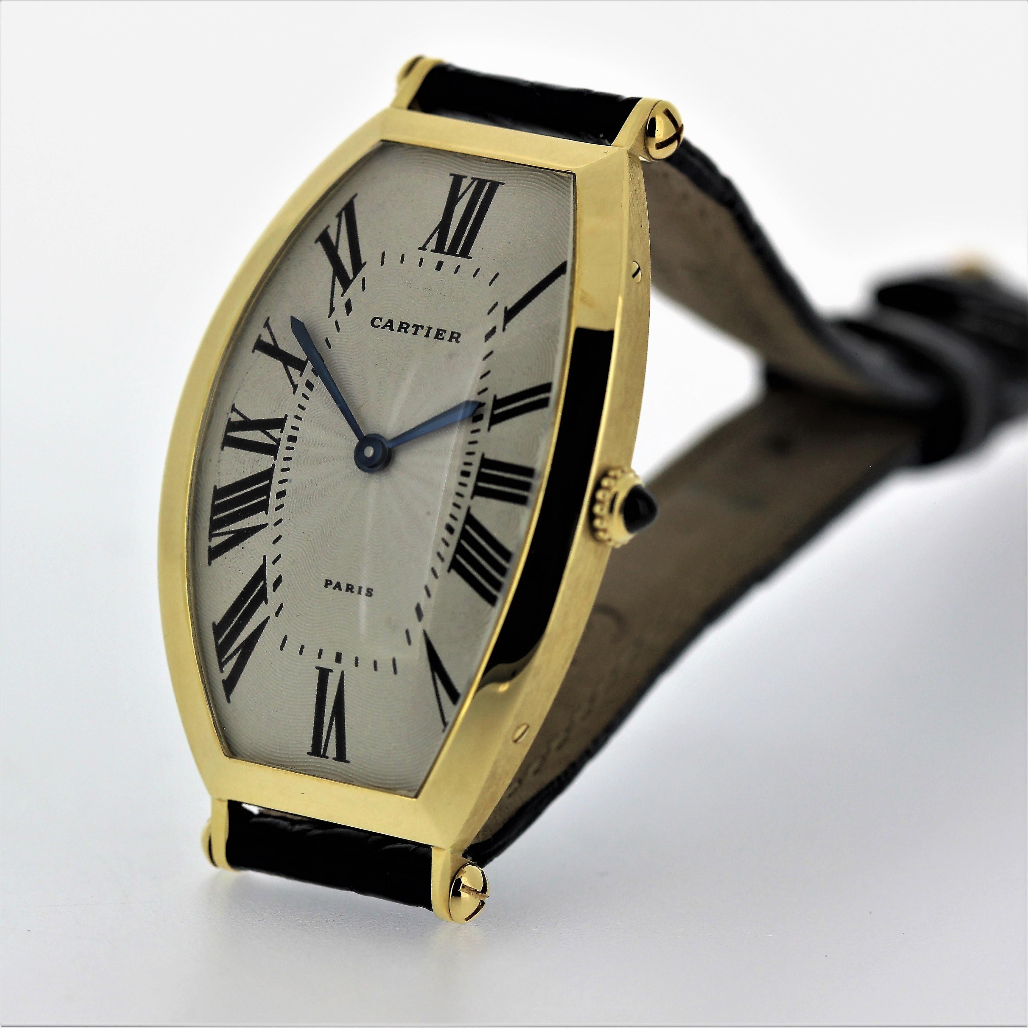 Introduction:
This Vintage Cartier Paris Tonneau watch is the large size, circa 1975-1980.  It is 18K yellow gold and measures 46 x 27mm with mechanical manual movement with 17 jewels.  It has a Cartier crocodile strap and 18K Cartier Buckle.  It is