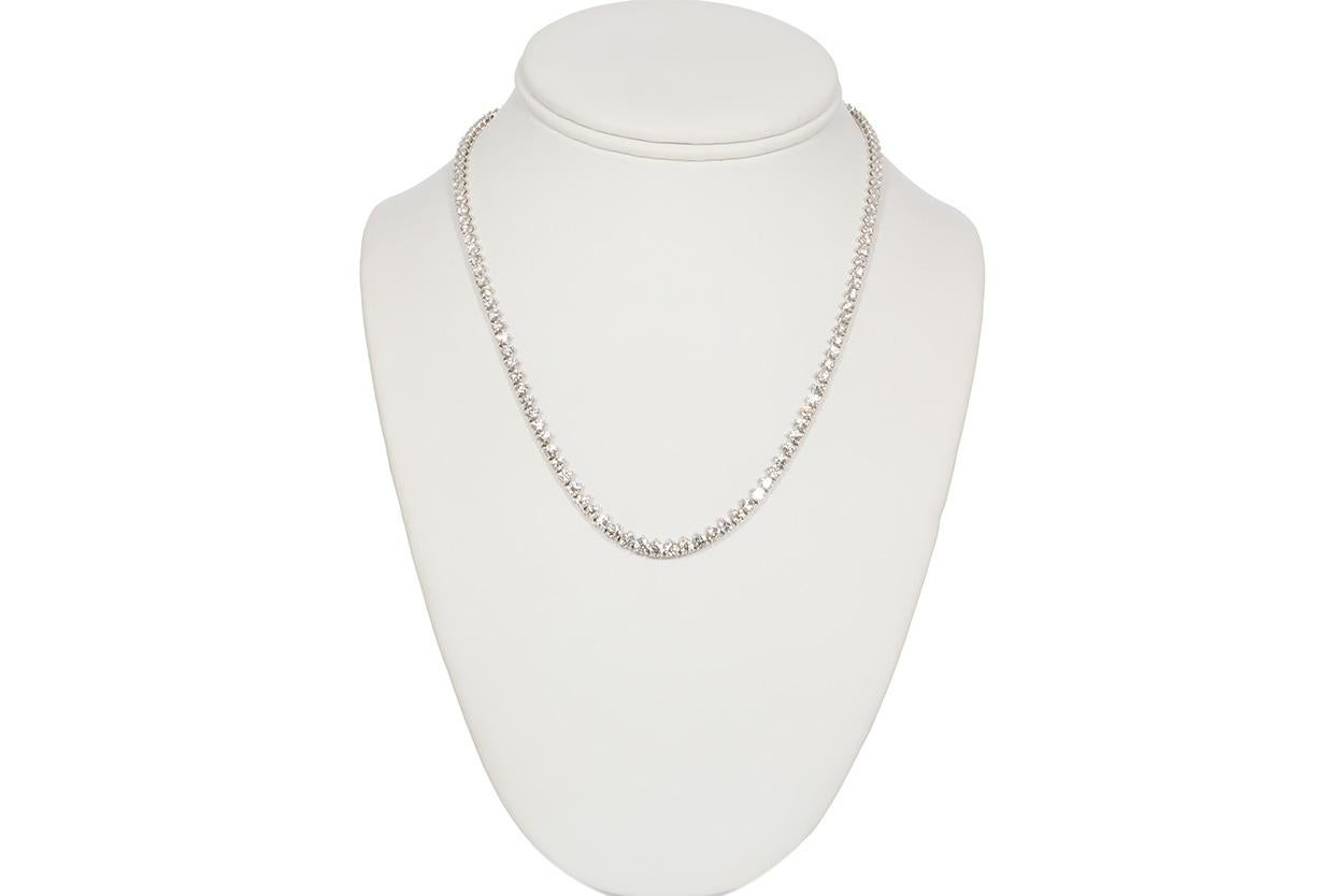 We are pleased to offer this Authentic Vintage Cartier Tennis Style Riviere Necklace. This stunning necklace is fashioned from platinum and features a 3-prong design set with 14.07ctw D-F/VVS-VS round brilliant cut diamonds. We believe it to be