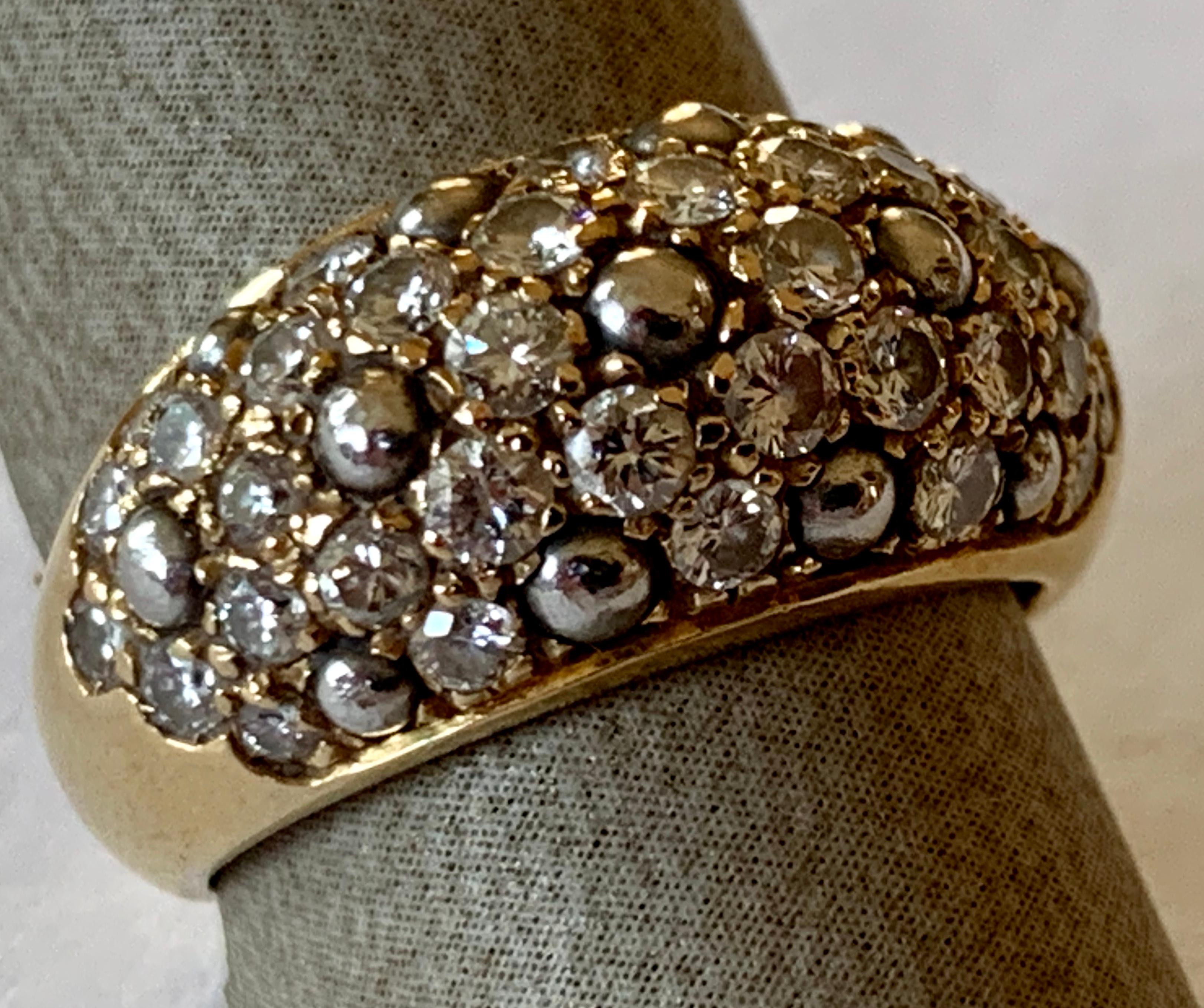 This gorgeous 18K yellow gold ring by Cartier is a mix of allure and glamour! The incredibly fabulous ring is  pave set with Diamonds that make the ring absolutely sublime. Signed and numbered. 
Ring Top Dimensions: 24mm x 12mm. 
The ring is