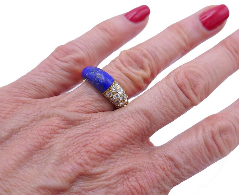 A classic Cartier vintage ring band made of 18k gold, diamond and lapis lazuli. 
The band has a dome looking shape. It is divided in two contrast halves by the gold line in the middle. One half is lapis lazuli, and another is sparkly diamonds. The