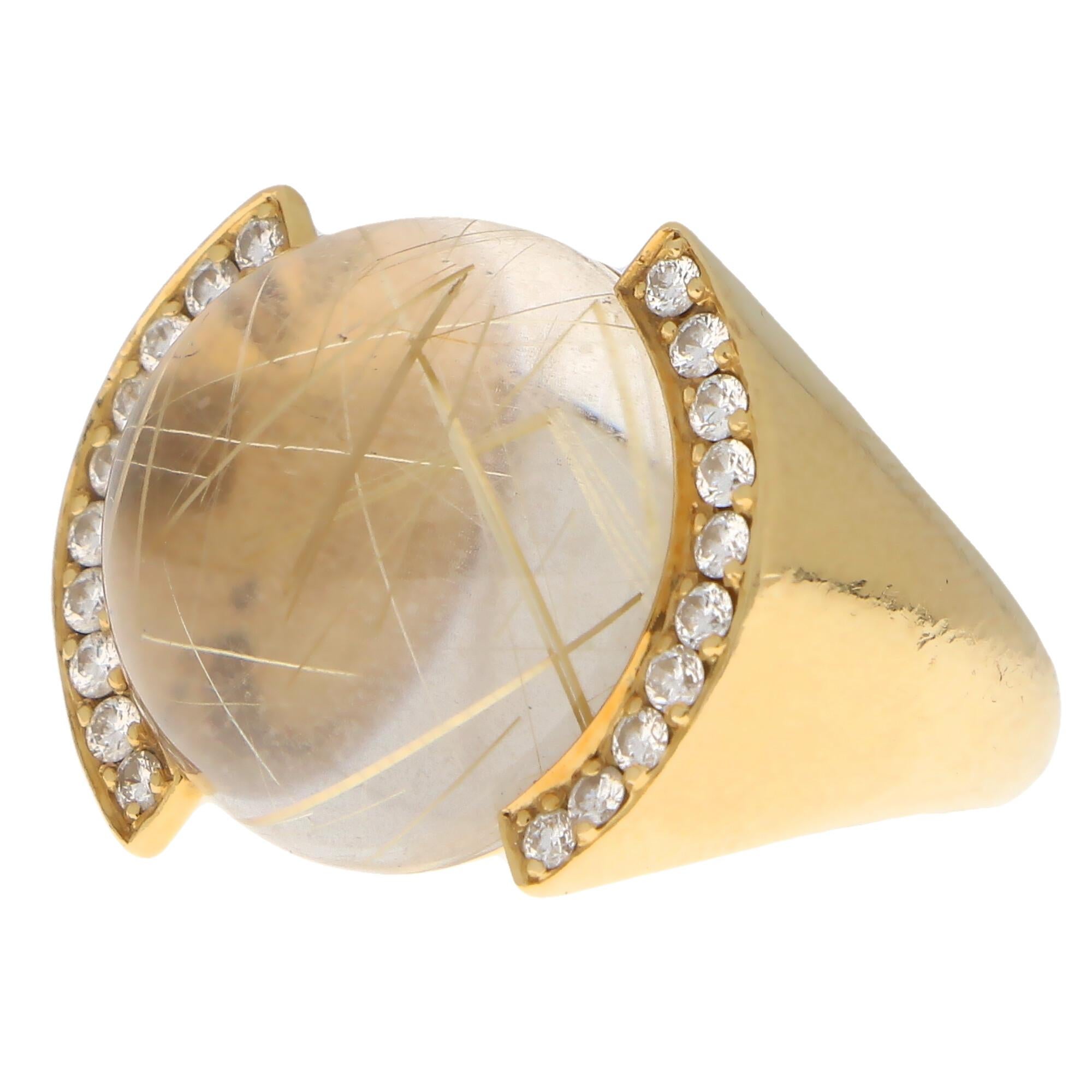 An extremely unique Cartier rutilated quartz and diamond bombe ring set in 18k yellow gold.

The ring is designed as a bombe style and is predominantly set with a round cabochon piece of rutilated quartz. This rutilated quartz has a fantastic array