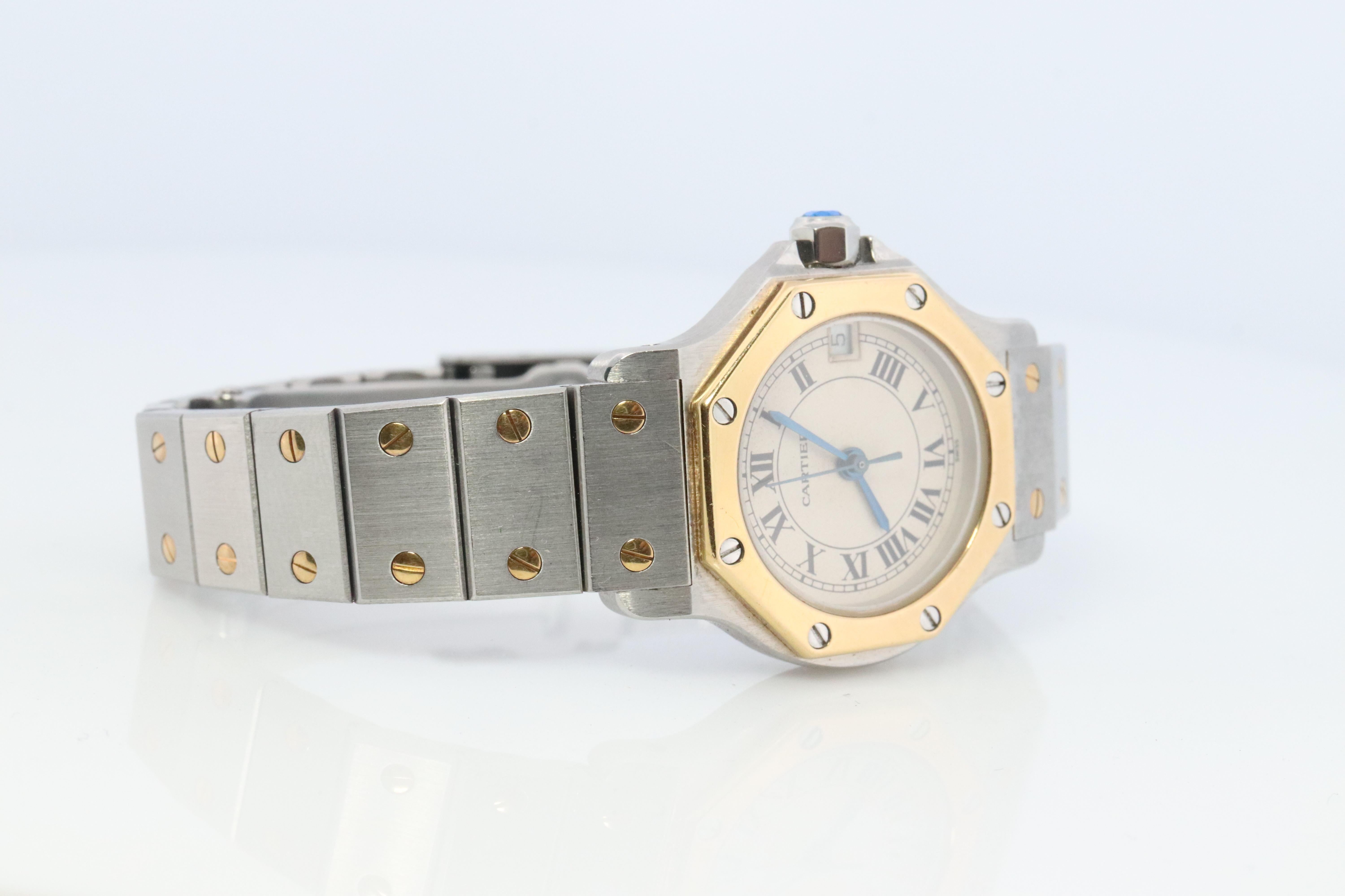 Genuine Cartier watch. Vintage Iconic Santos Sterling Silver and 18k Yellow gold.

Ref 187903

QUARTZ.

Condition: New battery installed. Serviced and New battery replaced. Original stainless steel Bracelet. Previously repaired. Weld is not seen