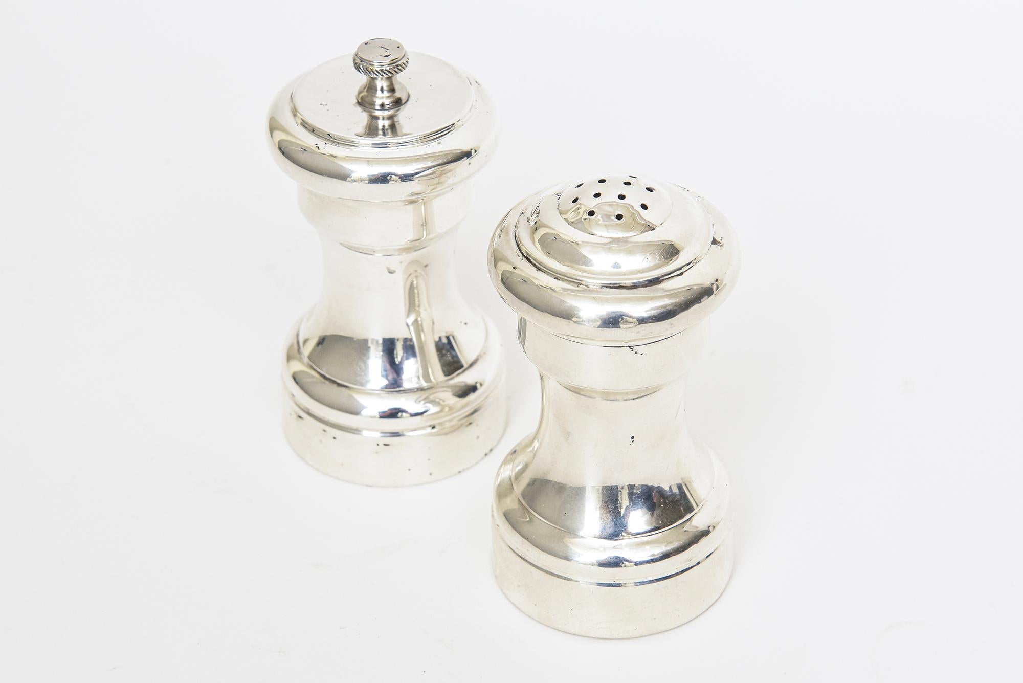 Thee lovely vintage signed Cartier salt and pepper shakers are from the 80's but have a nod to both modern and traditional styles. They are stamped Made In Italy on the base. The pepper mill is 4