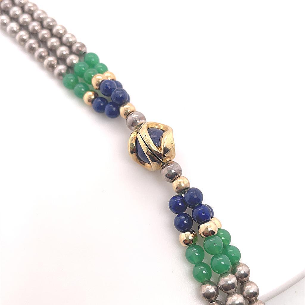 A vintage Cartier silver, chalcedony and lapis necklace in 18 karat yellow gold, circa 1960.

A rare and unusual piece by Cartier designed as as a triple row of fine silver beads, interspaced with lapis lazuli, chalcedony and 18 karat yellow gold