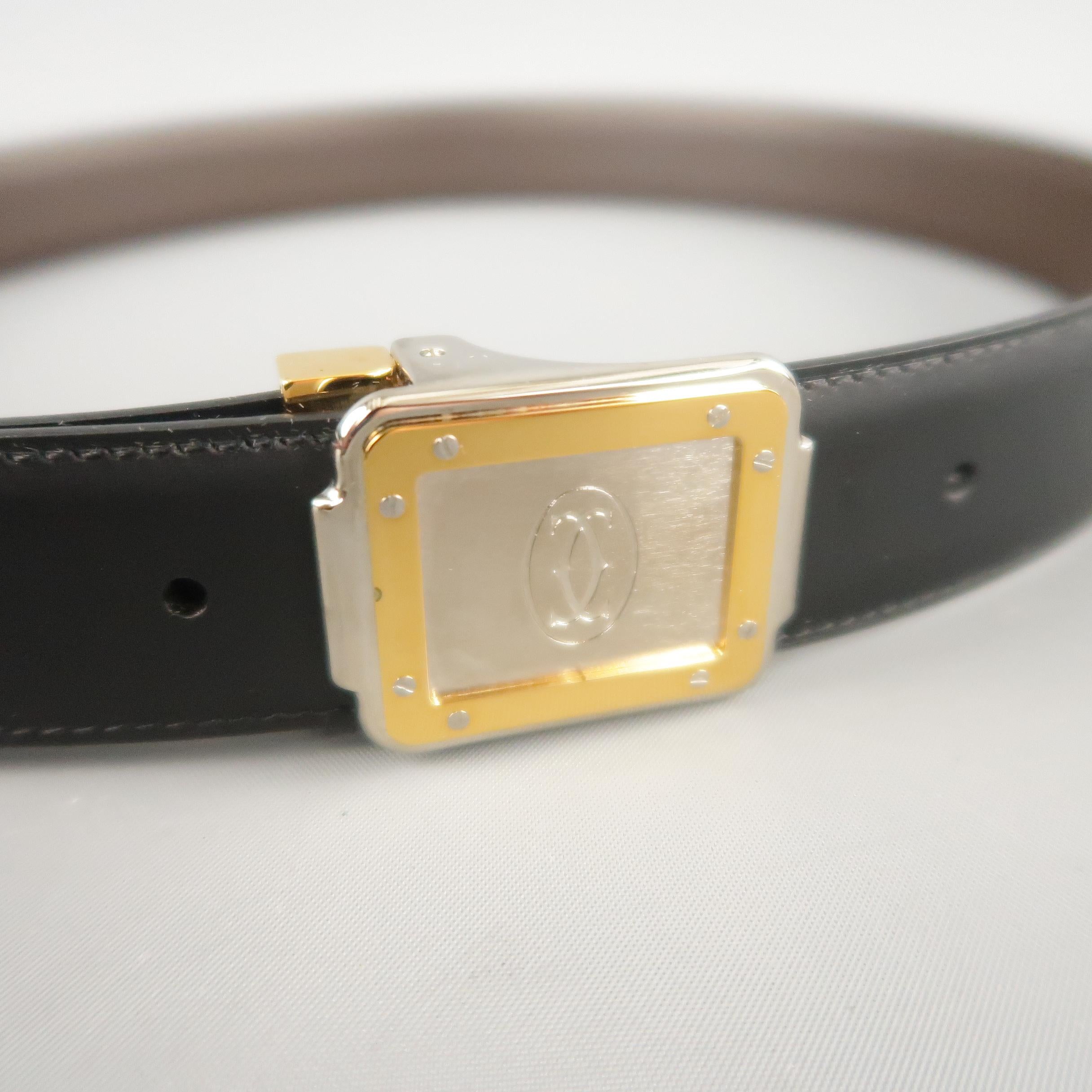 Vintage CARTIER dress belt features a reversible black and brown leather strap with a silver and gold tone embossed buckle. Includes original box and authentication cards.
 
Excellent Pre-Owned Condition.
Marked:(no size)
 
Length: 37 in.
Width: