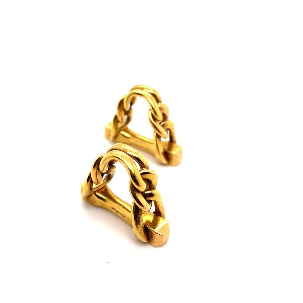 A pair of vintage Cartier stirrup cufflinks in twisted 18 karat yellow gold, circa 1950.

Each exquisite cufflink features twisted gold wire in the shape of a stirrup, with a beautiful polished finish and patina only found on vintage gold.

This